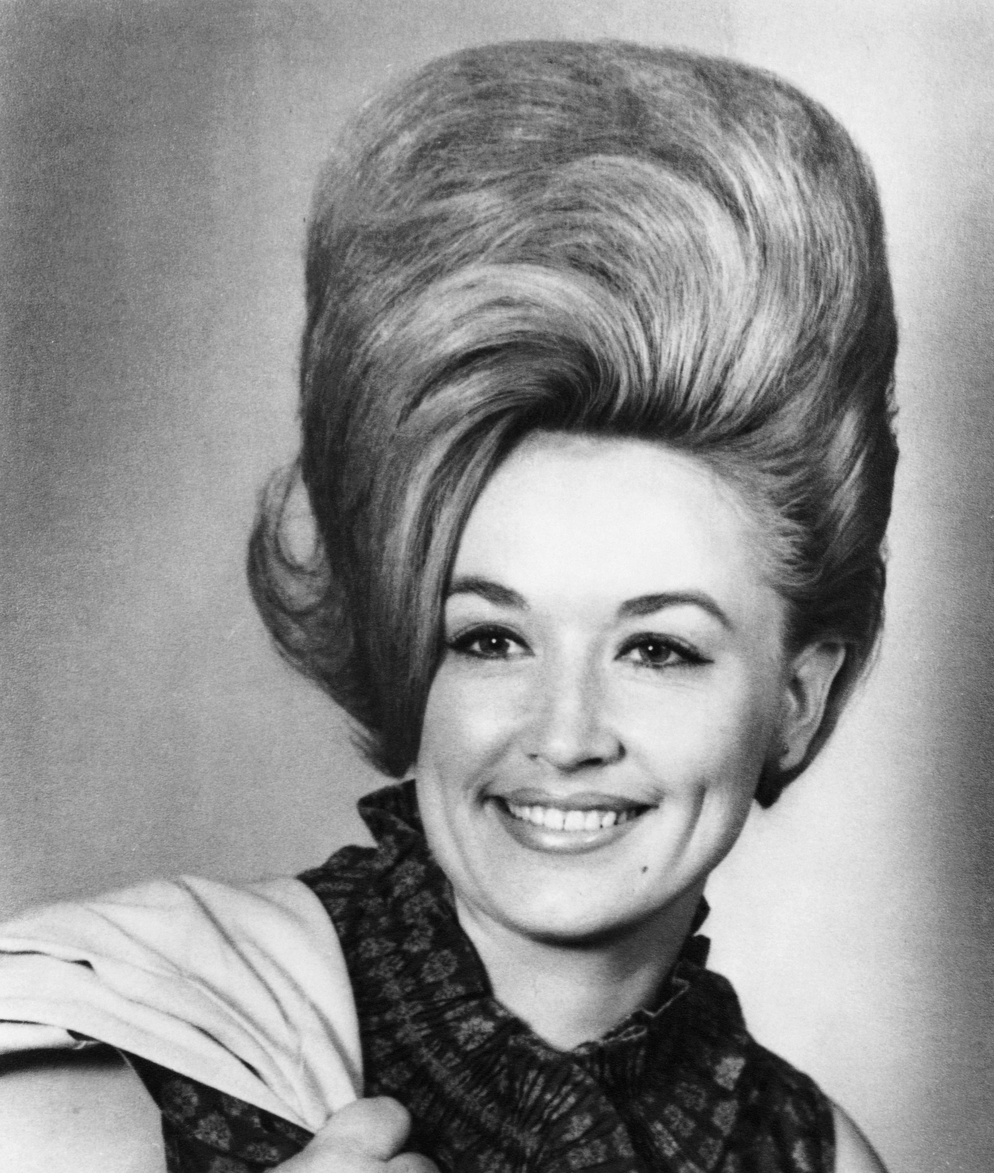 Parton left East Tennessee for Nashville the day after graduating high school in 1964, carrying ambitions that had begun years earlier on her family's porch. Her early career soon put her on a path from Appalachian poverty to national recognition. | Source: Getty Images