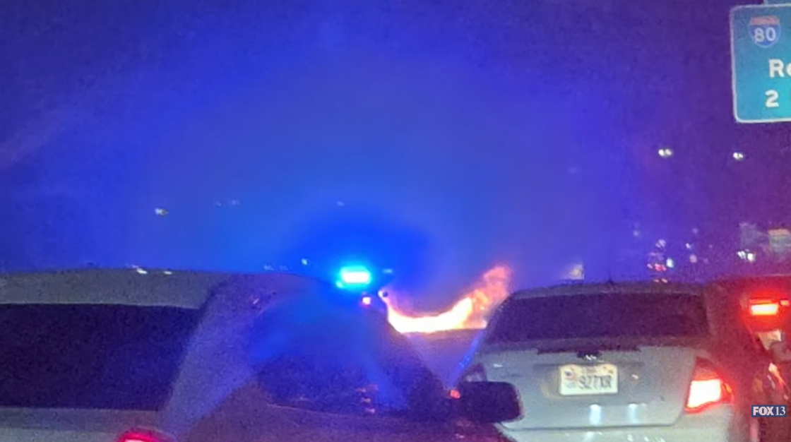 Flames visible from the crash site, as seen by drivers on I-15 northbound, as posted on November 30, 2025 | Source: YouTube/Fox13now