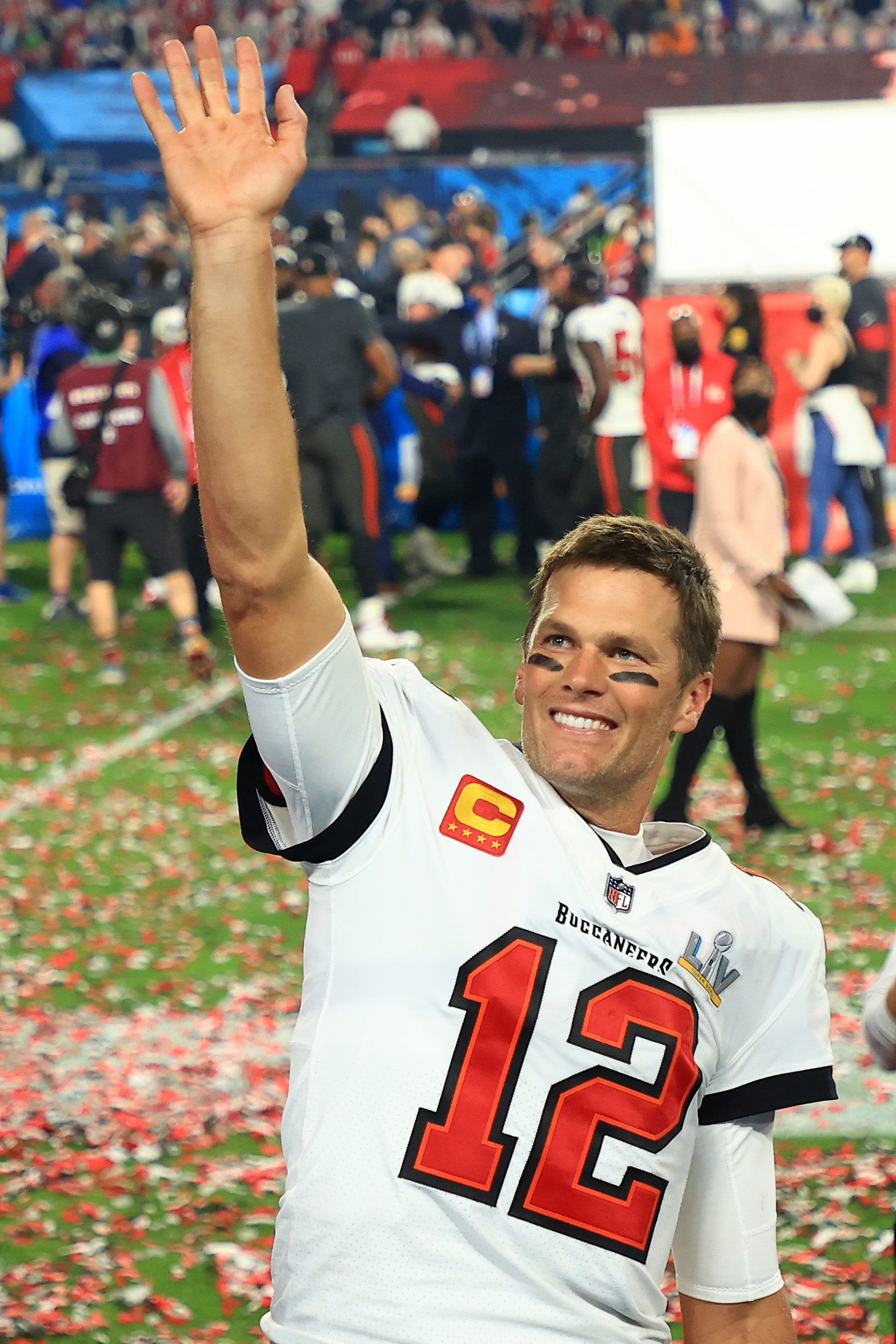 Tom Brady, now with the Tampa Bay Buccaneers, throws his hands up in triumph and flashes a toothy grin as he celebrates defeating the Kansas City Chiefs in Super Bowl LV at Raymond James Stadium in Tampa, Florida.