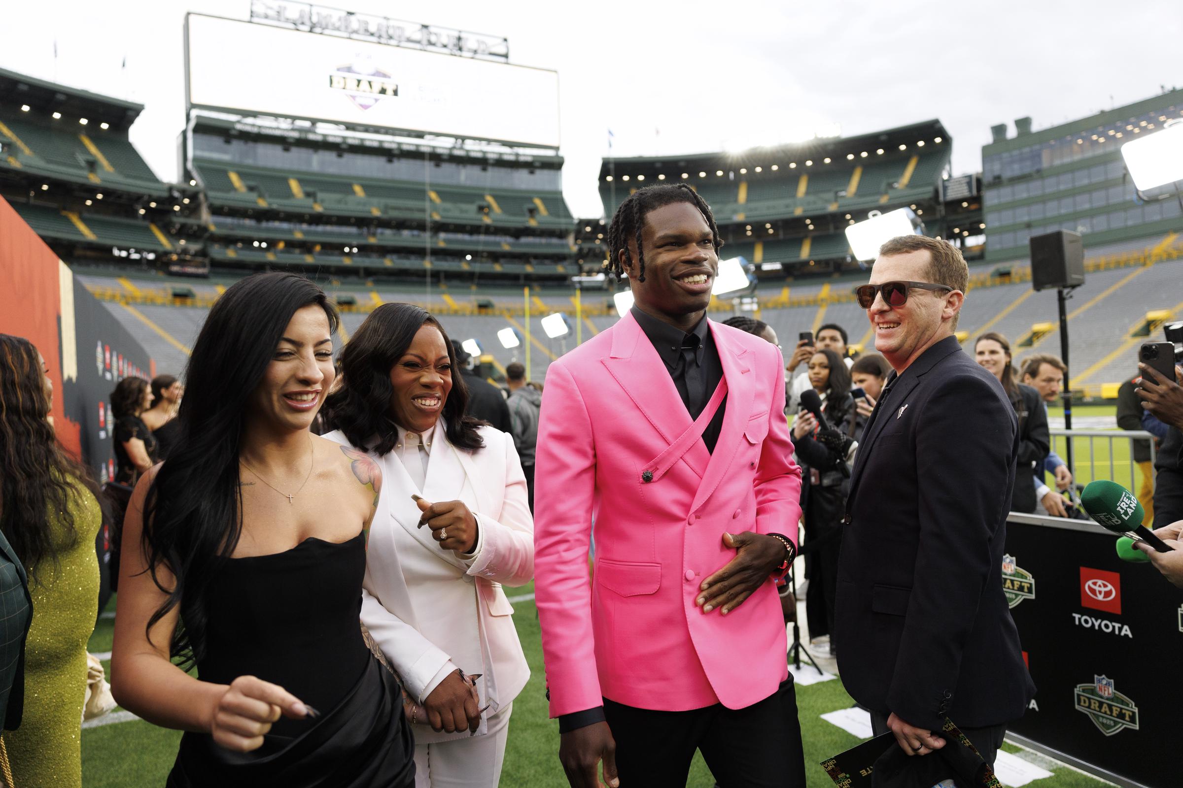 Leanna Lenee, Ferrante Edmonds, and Travis Hunter during the first round of the 2025 NFL Draft on April 24 in Green Bay, Wisconsin. | Source: Getty Images