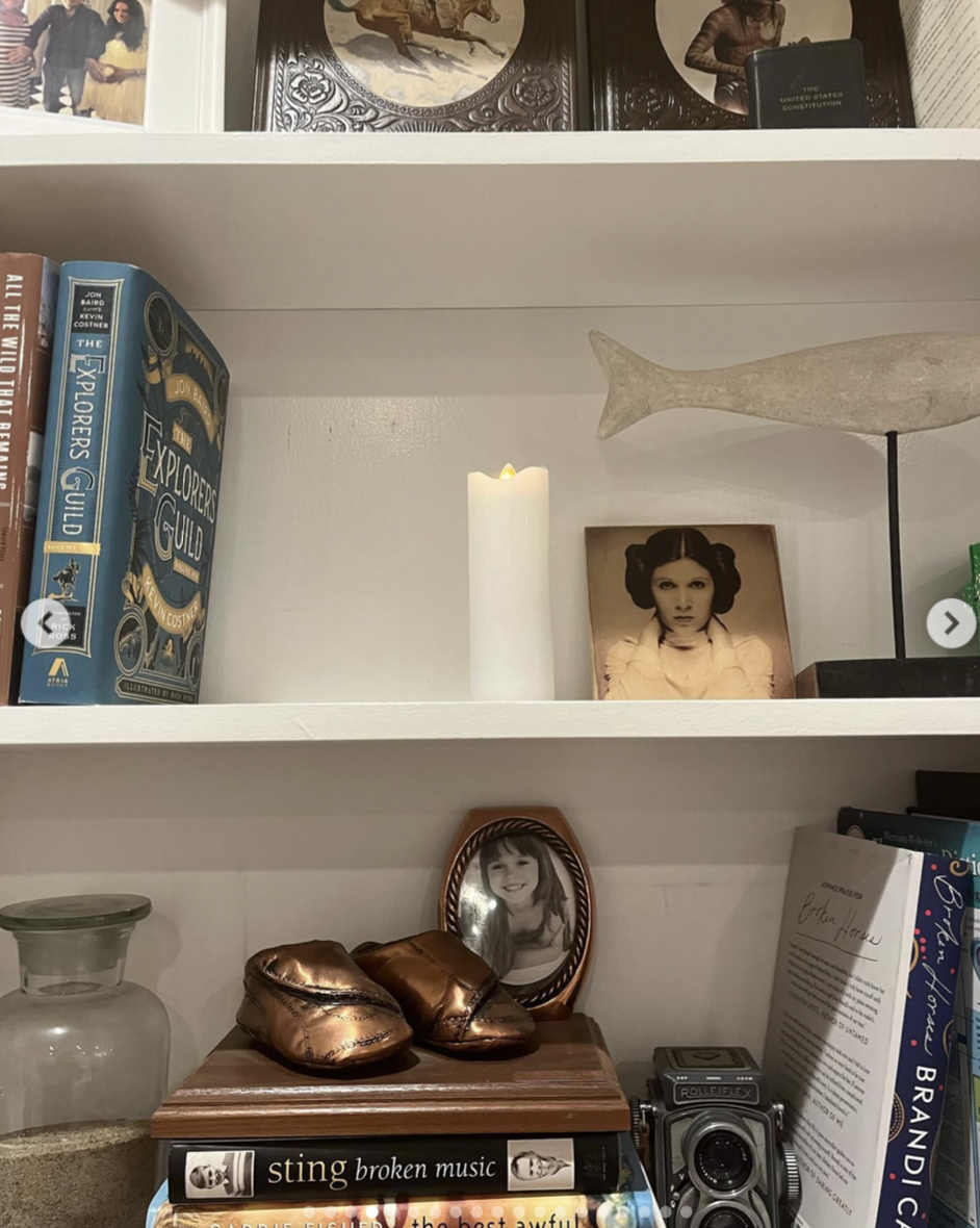 The shelves were filled with books, framed family photographs, an old camera, bronzed baby shoes, and other keepsakes collected over the years. | Source: Instagram/ Mabel Lowe