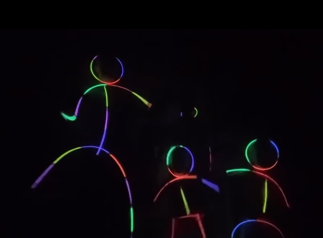 Colorful neon outlines show several figures dancing together against a dark background in Hilary Swank's Instagram video. The playful family scene drew attention as viewers began discussing the possible meaning behind her announcement. | Source: Instagram/hilaryswank