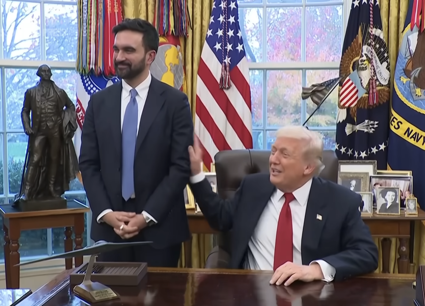 Donald Trump touches Zohran Mamdani's arm during a meeting in the Oval Office of the White House on November 21, 2025 | Source: YouTube/@AssociatedPress