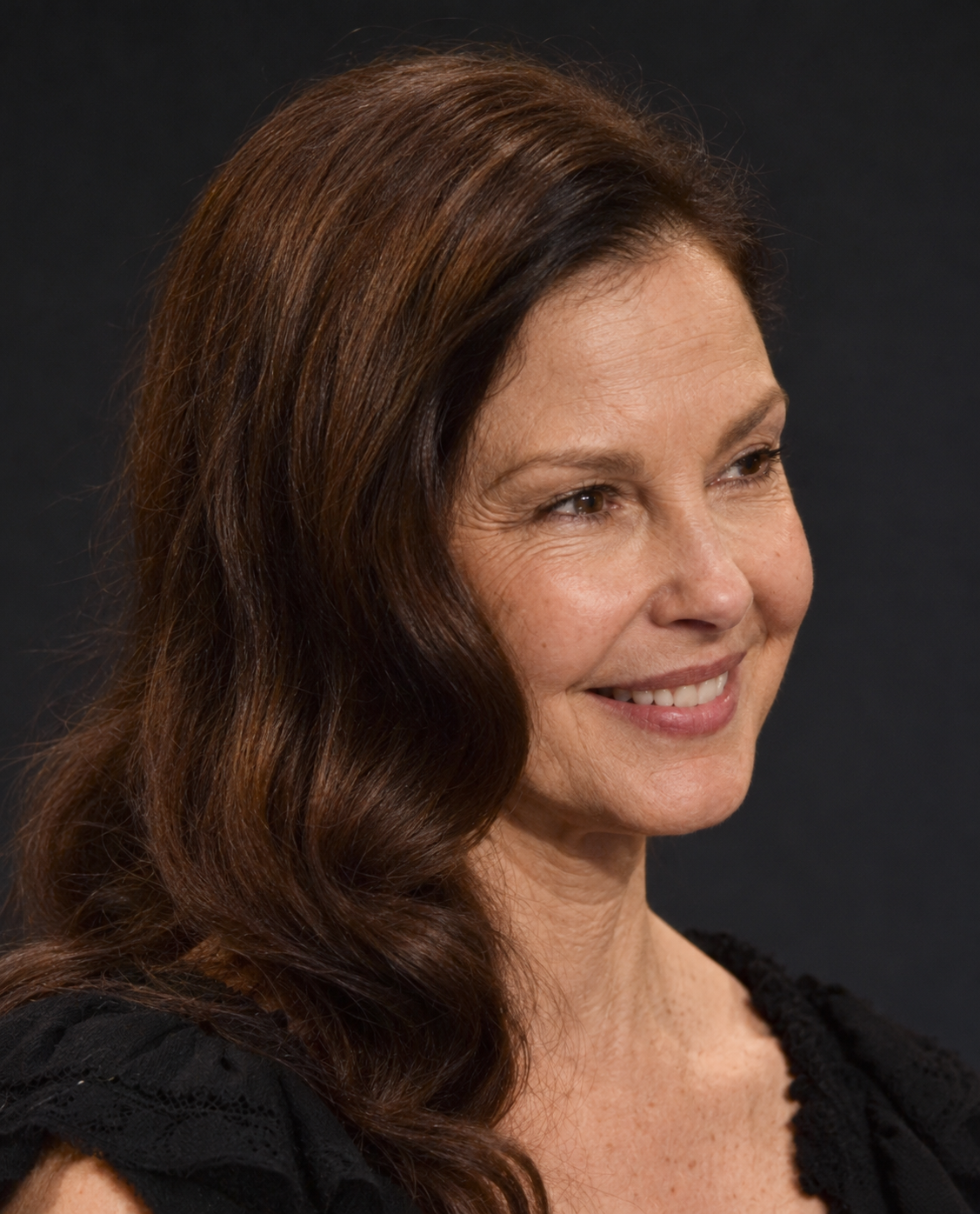 A computer-generated portrait offers a smiling close-up, pairing a relaxed expression with long, loosely styled hair. | Source: ChatGPT