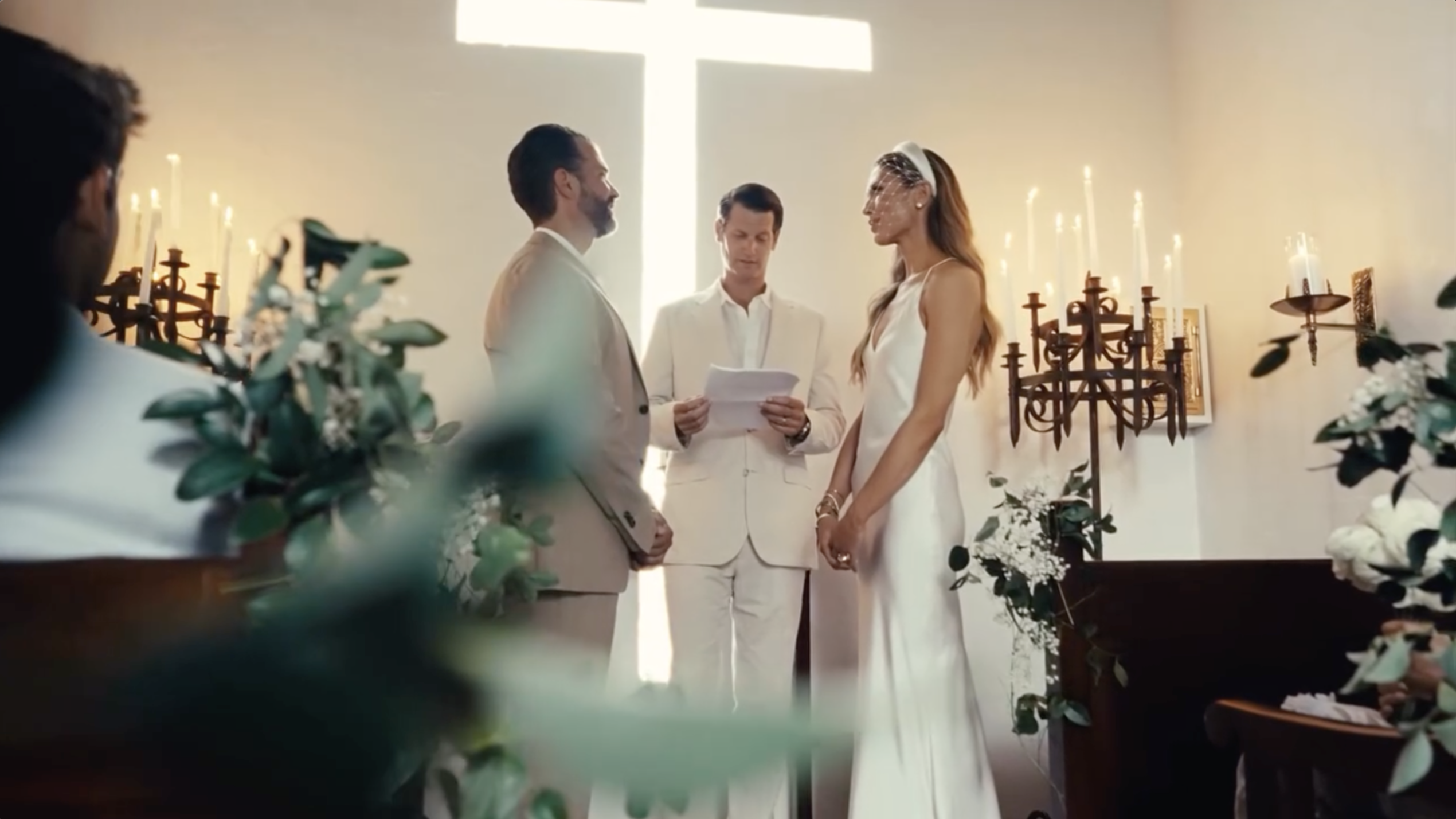 Donald Trump Jr. and Bettina Anderson stand before the officiant as they exchange vows beneath a glowing cross. | Source: Instagram/donaldjtrumpjr