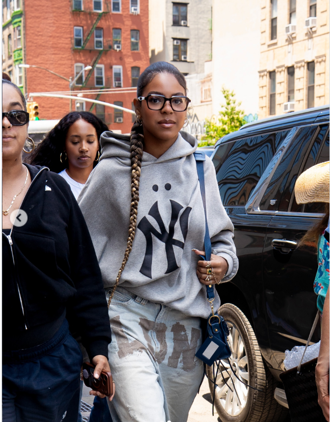Blue Ivy kept things casual yet stylish, pairing a slouchy hoodie and wide-leg jeans with a waist-length braid, black-framed glasses, and a handful of rings. | Source: Instagram/therealnicoleeeeee and fashionbombdaily