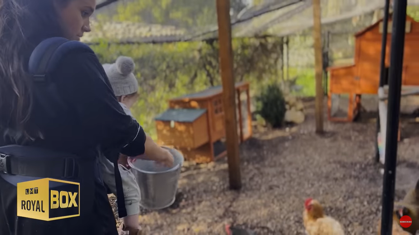 Meghan Markle and Princess Lilibet feeding chickens | Source: YouTube/LMT