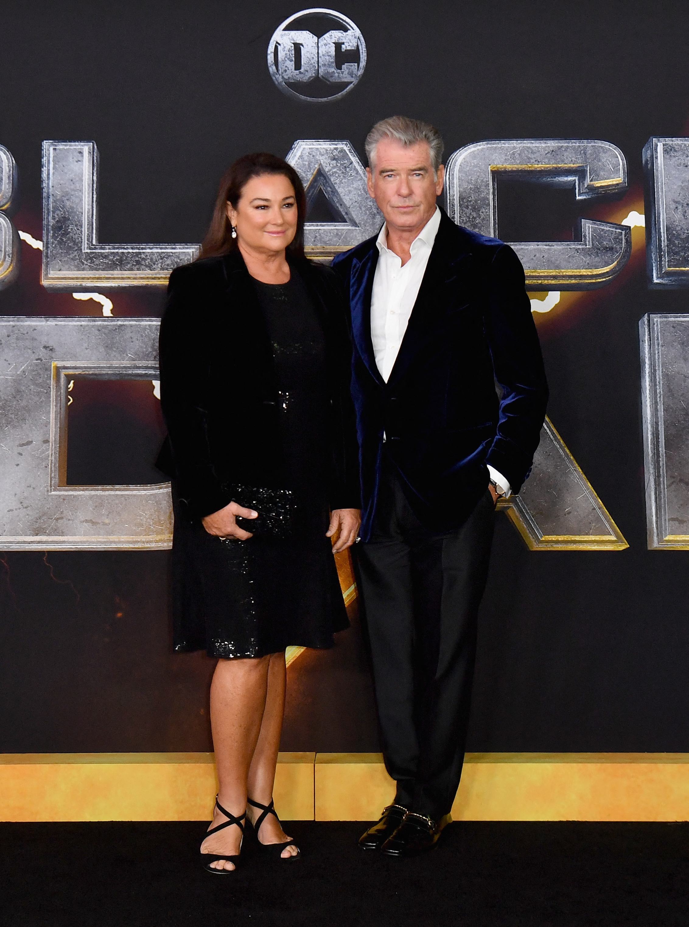 Keely Shaye Smith joined Pierce Brosnan at the "Black Adam" premiere in a black sequined dress, while the actor showed off his silver hair and kept his wife close on the red carpet. | Source: Getty Images.