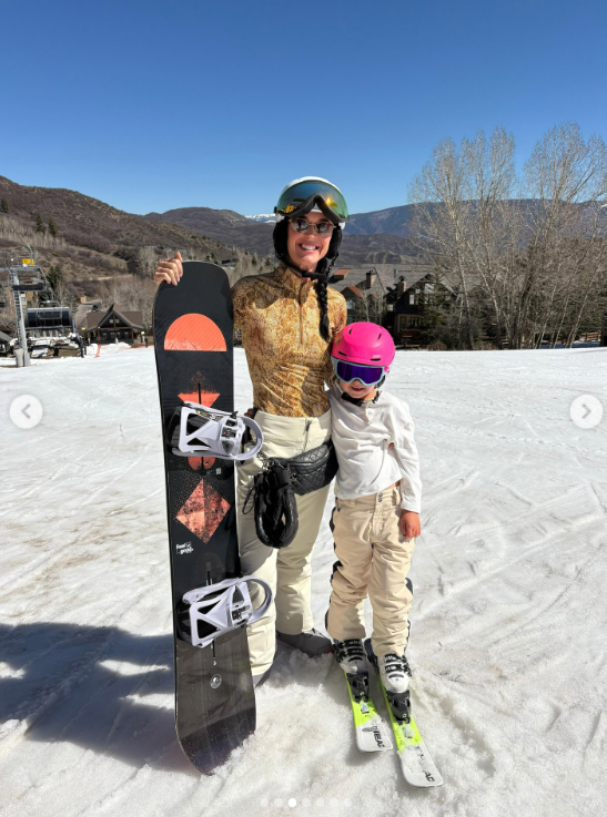 Katy Perry spends a fun day in the snow with her daughter, Daisy Dove Bloom. The singer holds a snowboard while Daisy stands beside her on skis, enjoying some mother-daughter time on the slopes. | Source: Instagram/katyperry