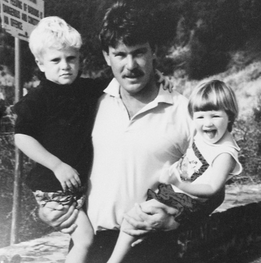 Candice Swanepoel poses with her father and brother in this black-and-white childhood photograph. The family snapshot captures a happy moment from her early years, offering a glimpse into the South African family life she has fondly remembered.  | Source: Instagram/candiceswanepoel