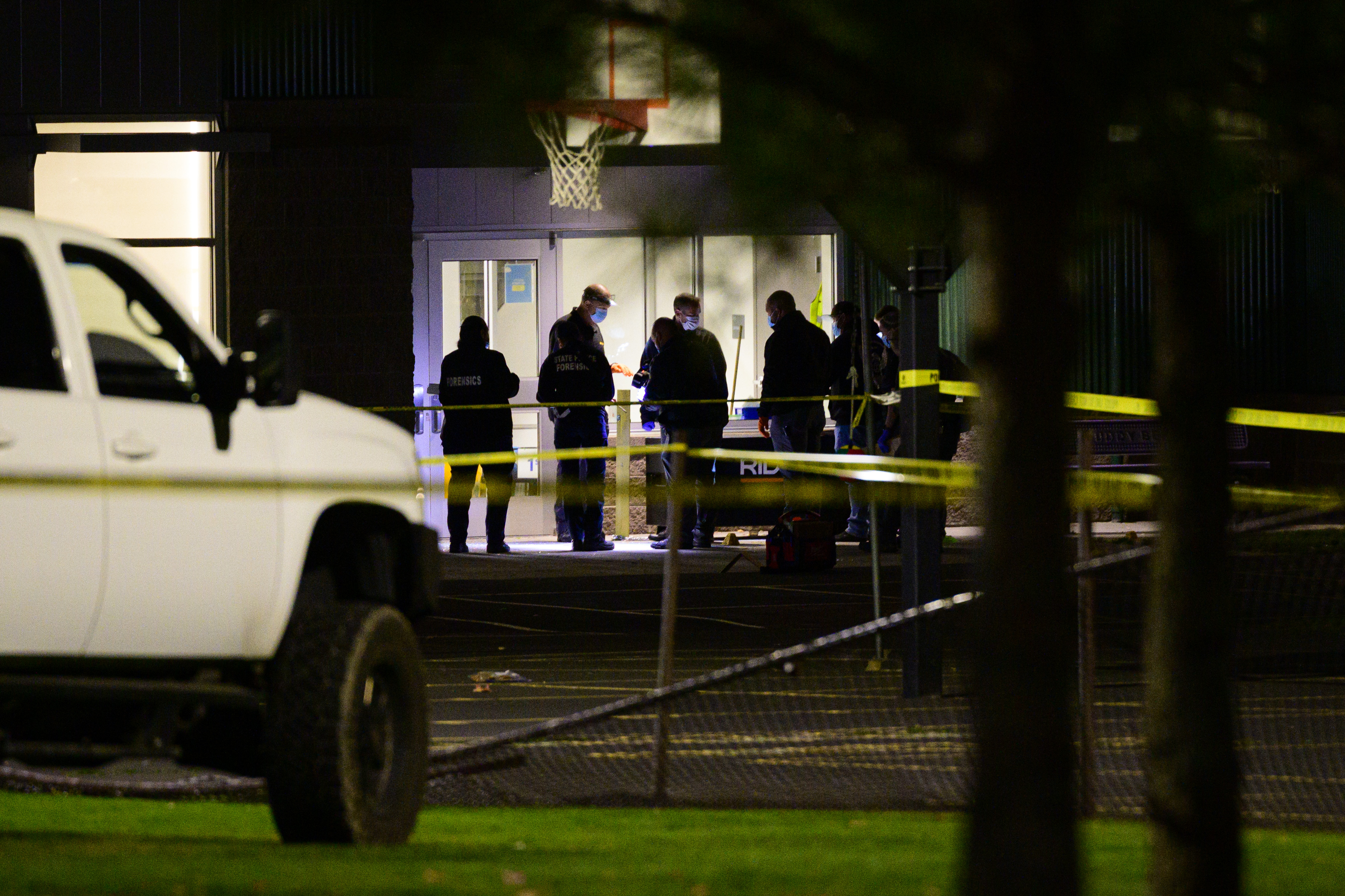 Investigators work inside the police perimeter at Silver Rail Elementary School following the deadly shooting. | Source: Getty Images