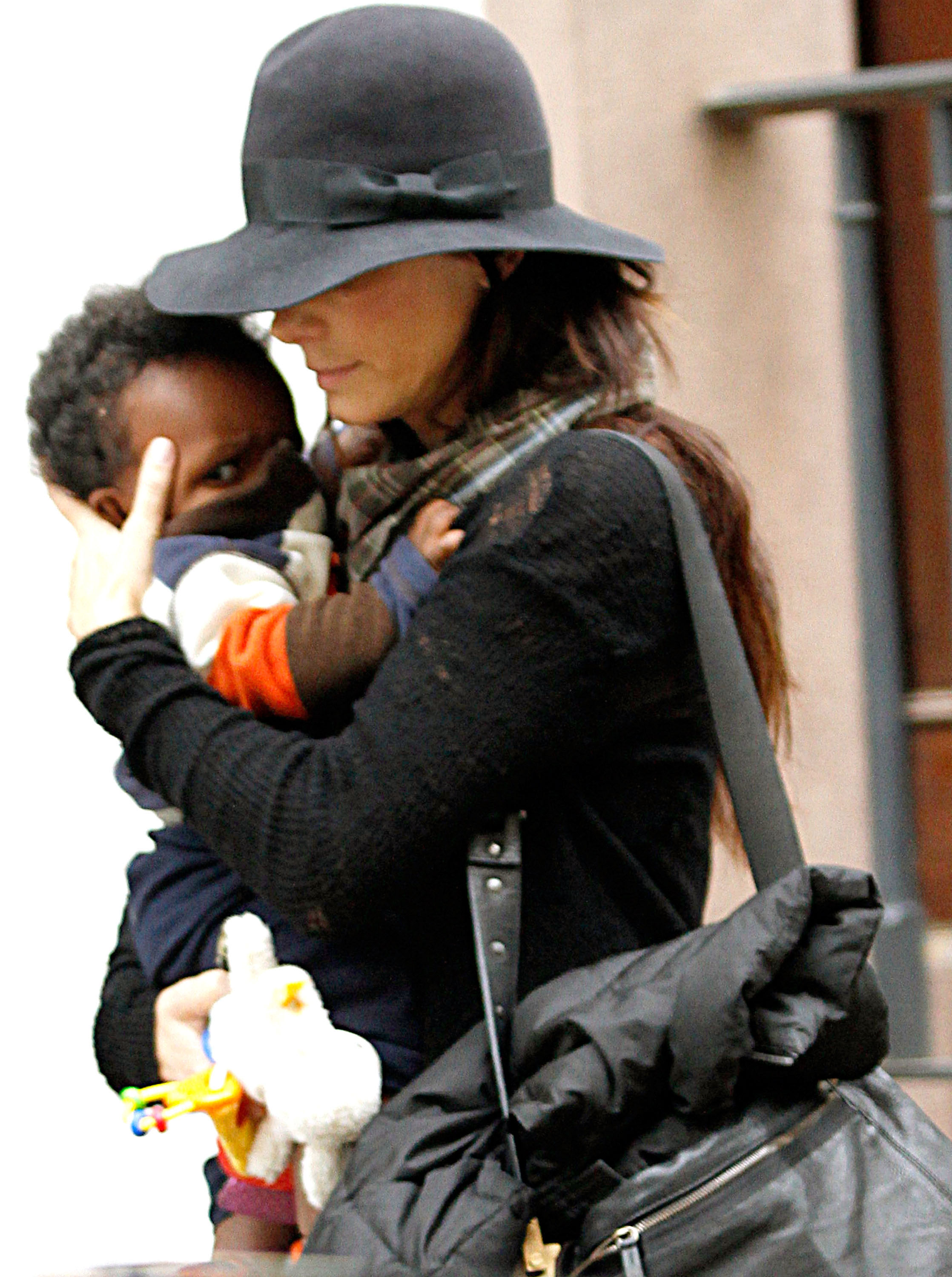 Sandra Bullock brought her children into the spotlight for the first time after making a rare revelation about them at the premiere of "Practical Magic 2." During this outing, she and her son Louis Bullock walked the streets of Manhattan on November 6, 2010, in New York City, New York. | Source: Getty Images