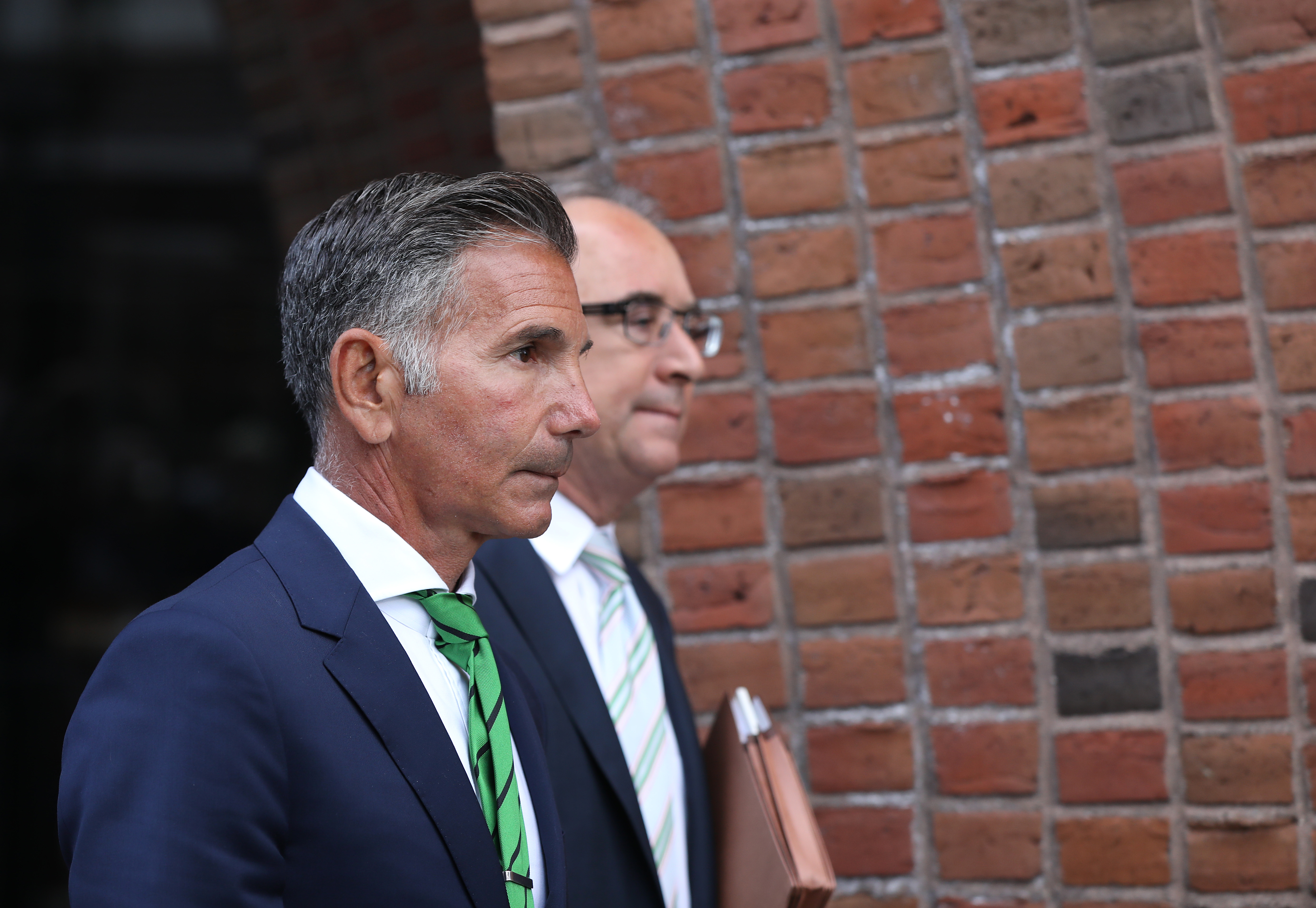 Giannulli leaves federal court in Boston on April 3, 2019, weeks after the college admissions case became public. More than a year later, he pleaded guilty to a conspiracy charge and received a five-month prison sentence. | Source: Getty Images