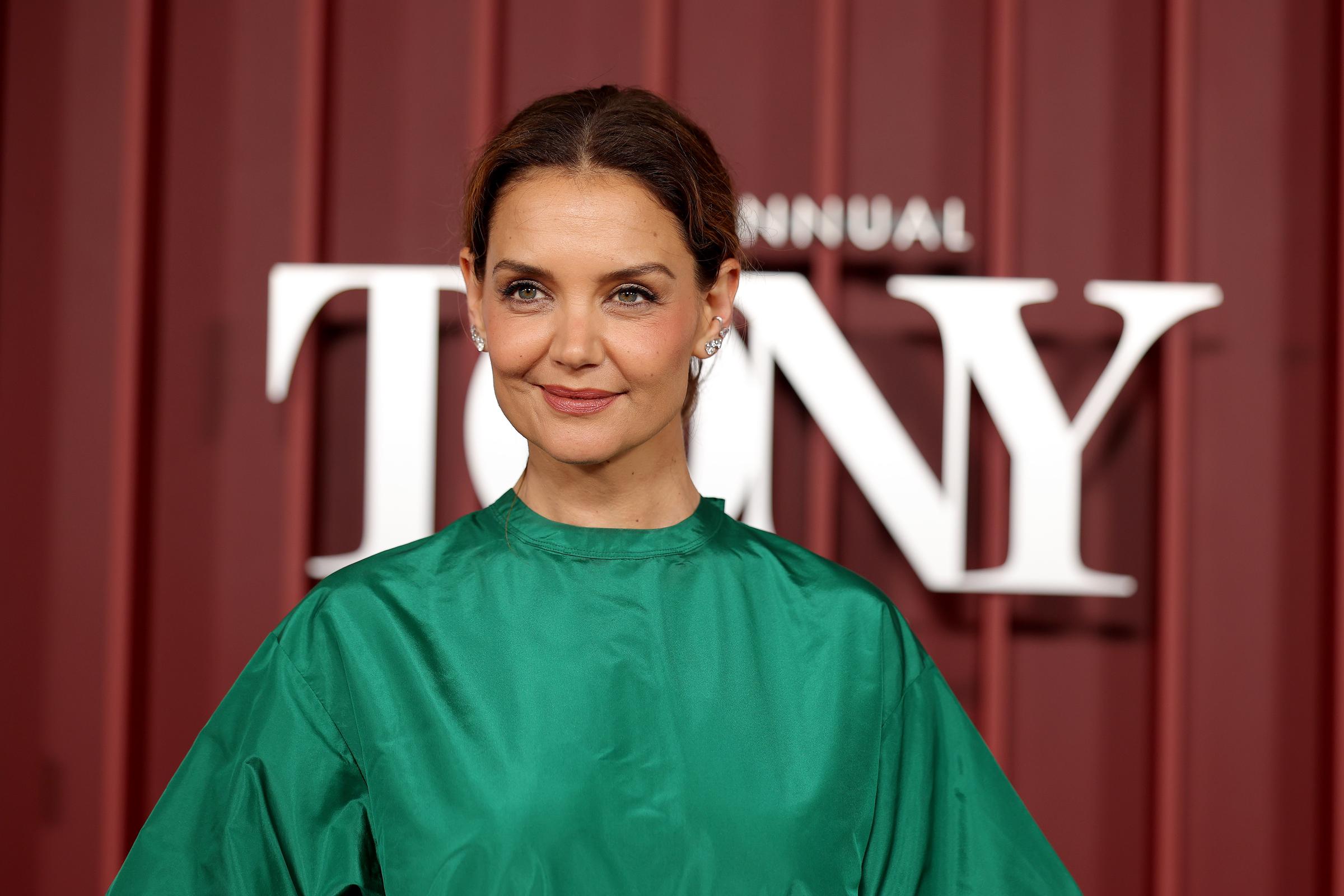 Katie Holmes attends the 78th Annual Tony Awards in a bold green satin top, pairing the vibrant look with a soft updo and minimal makeup as she arrives to present at Radio City Music Hall in New York City.