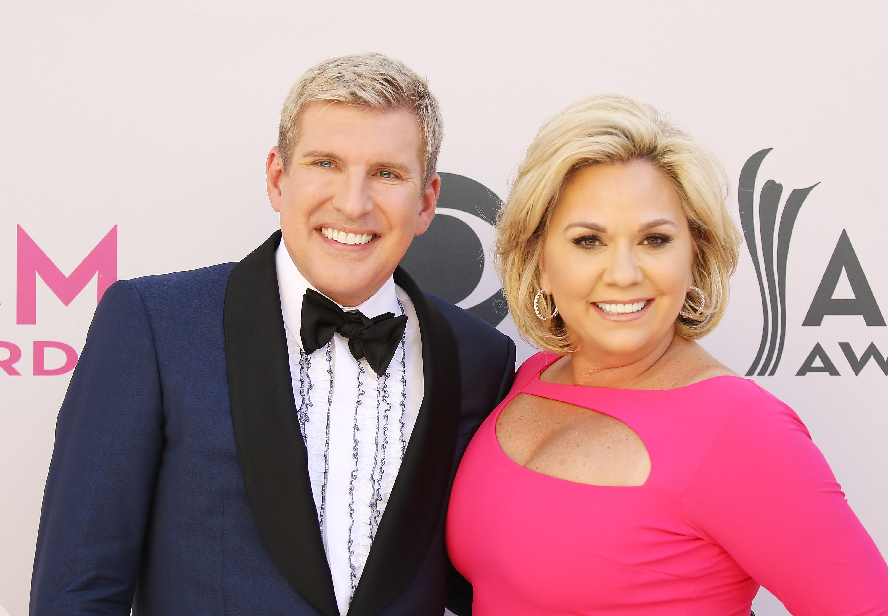 Todd and Julie Chrisley pose together at the Academy of Country Music Awards in Las Vegas in April 2017. The couple's legal history has become part of the wider story surrounding their daughter's engagement. | Source: Getty Images