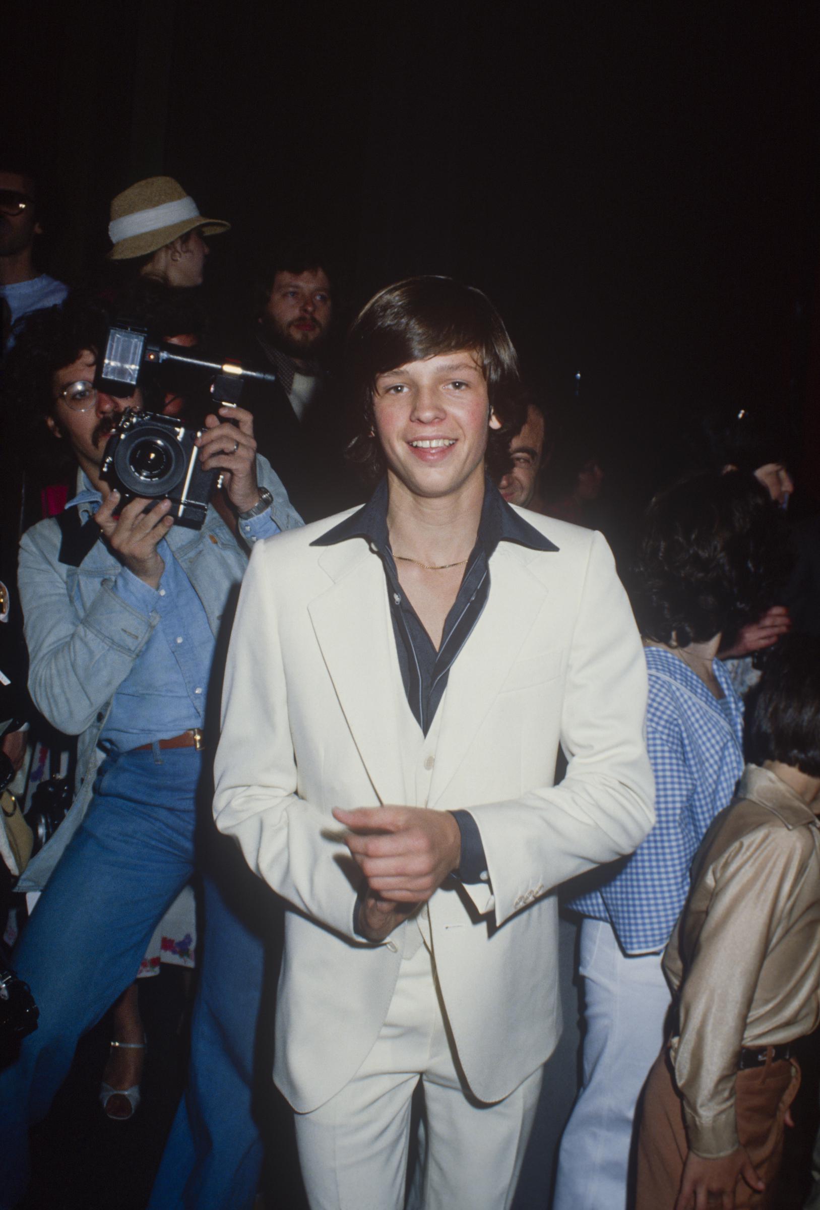 As one of the only former child stars on this list with darker hair, Jimmy McNichol was set to become a teen idol. In this photo, he posed for a portrait wearing a white three-piece suit and a black shirt circa 1970, in New York City, New York. | Source: Getty Images