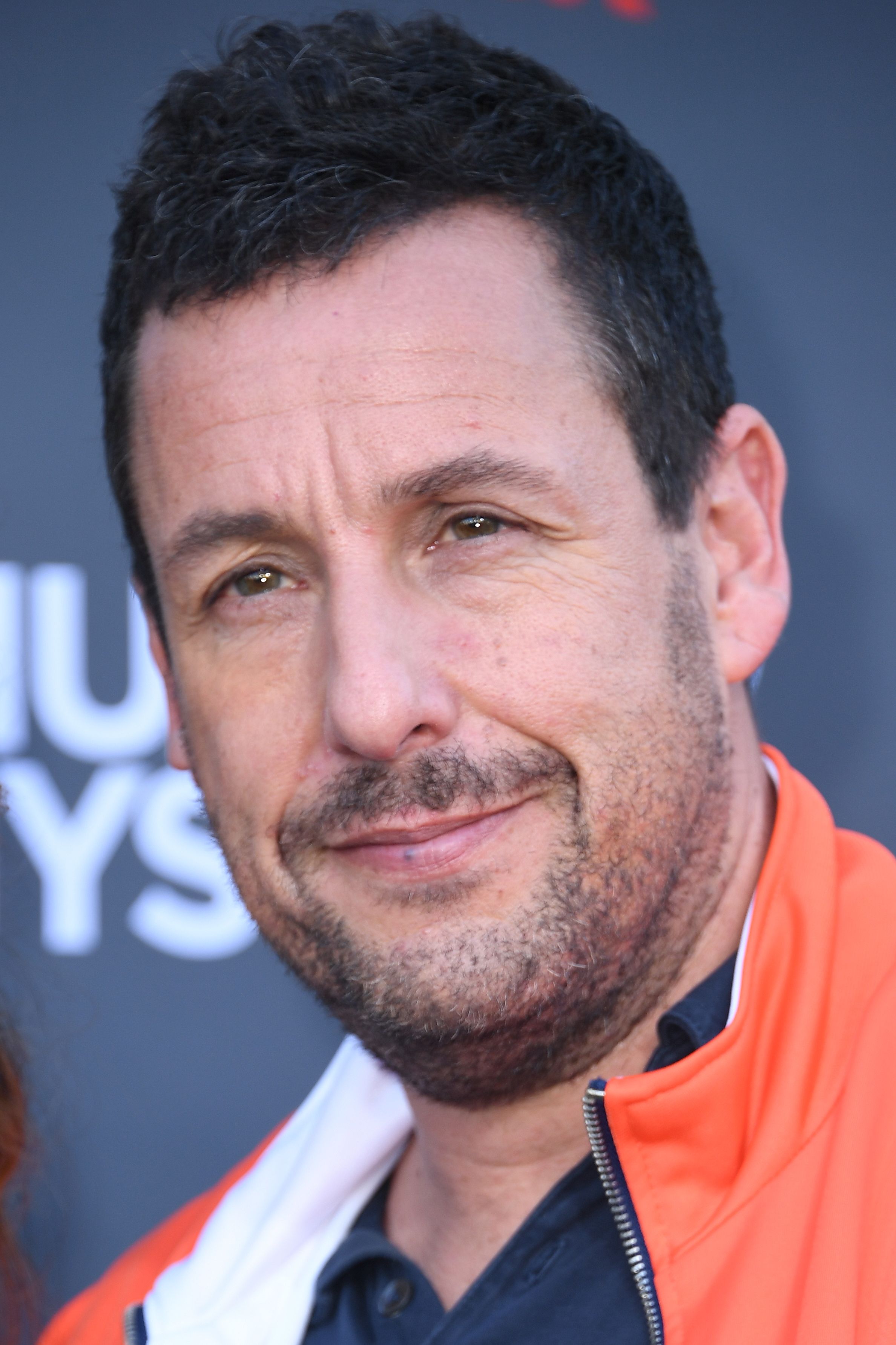 Adam Sandler, pictured at a 2019 Netflix premiere, is known for bringing his relaxed personal style to Hollywood events. | Source: Getty Images