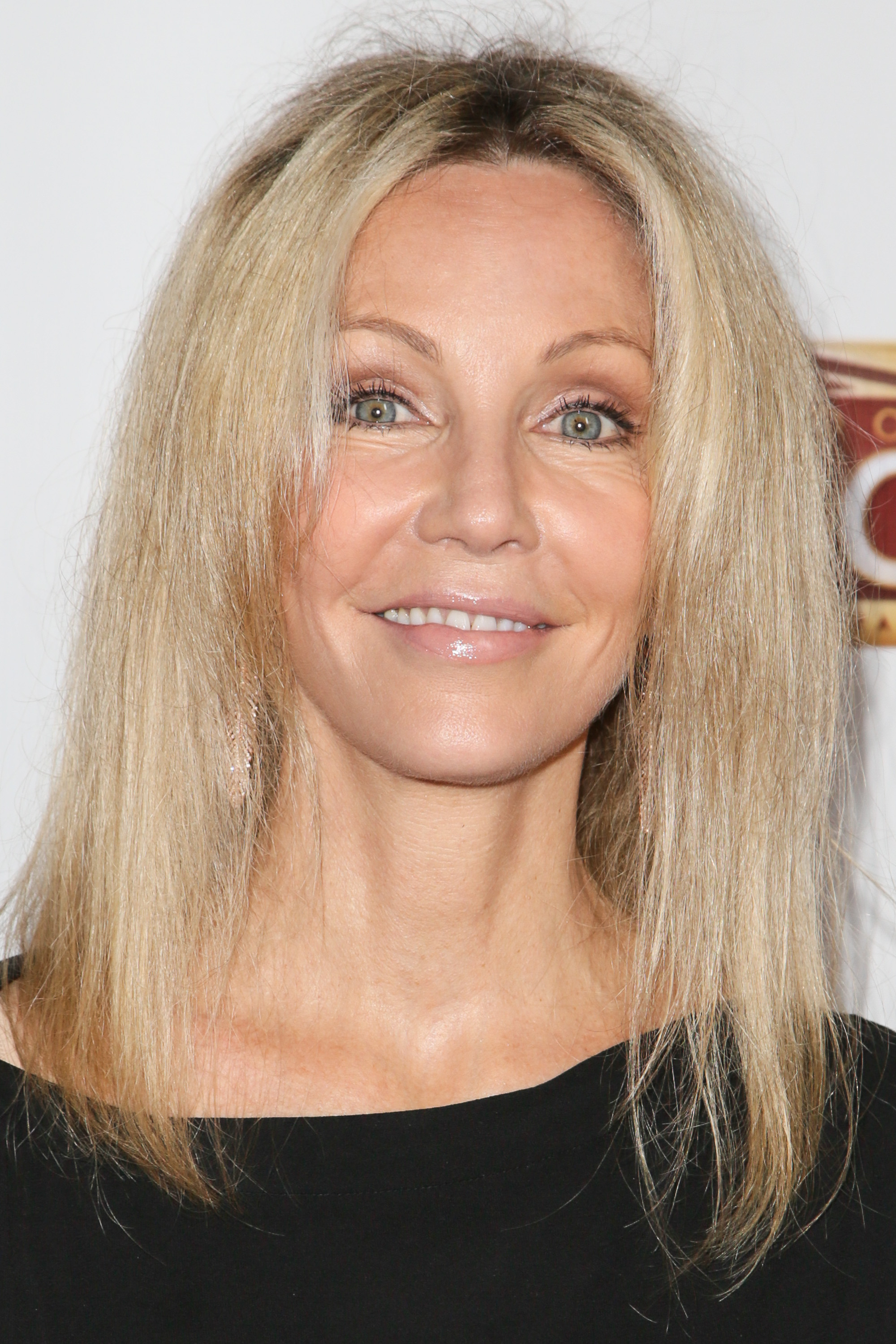 Locklear's facial appearance had already evolved considerably from the voluminous hairstyles and youthful portraits of the 1980s. Years of public appearances would later provide the photographs on which cosmetic-surgery speculation was based. | Source: Getty Images