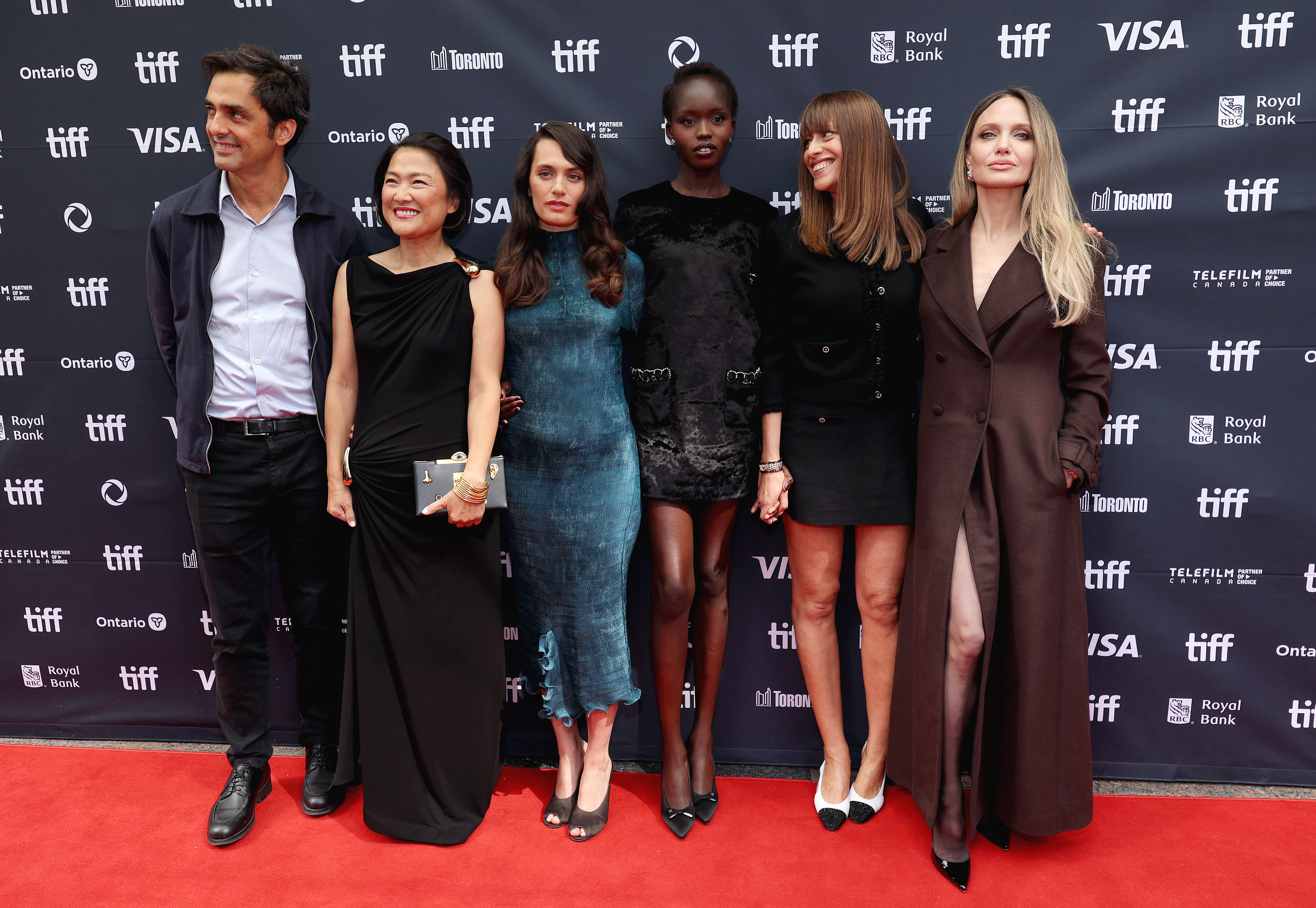 Angelina Jolie, Charles Gillibert, Zhang Xin, Ella Rumpf, Anyier Anei, and Alice Winocour pose on the red carpet at the premiere of "Couture" during the TIFF at Princess of Wales Theater in Toronto, Ontario on September 7, 2025 | Source: Getty Images