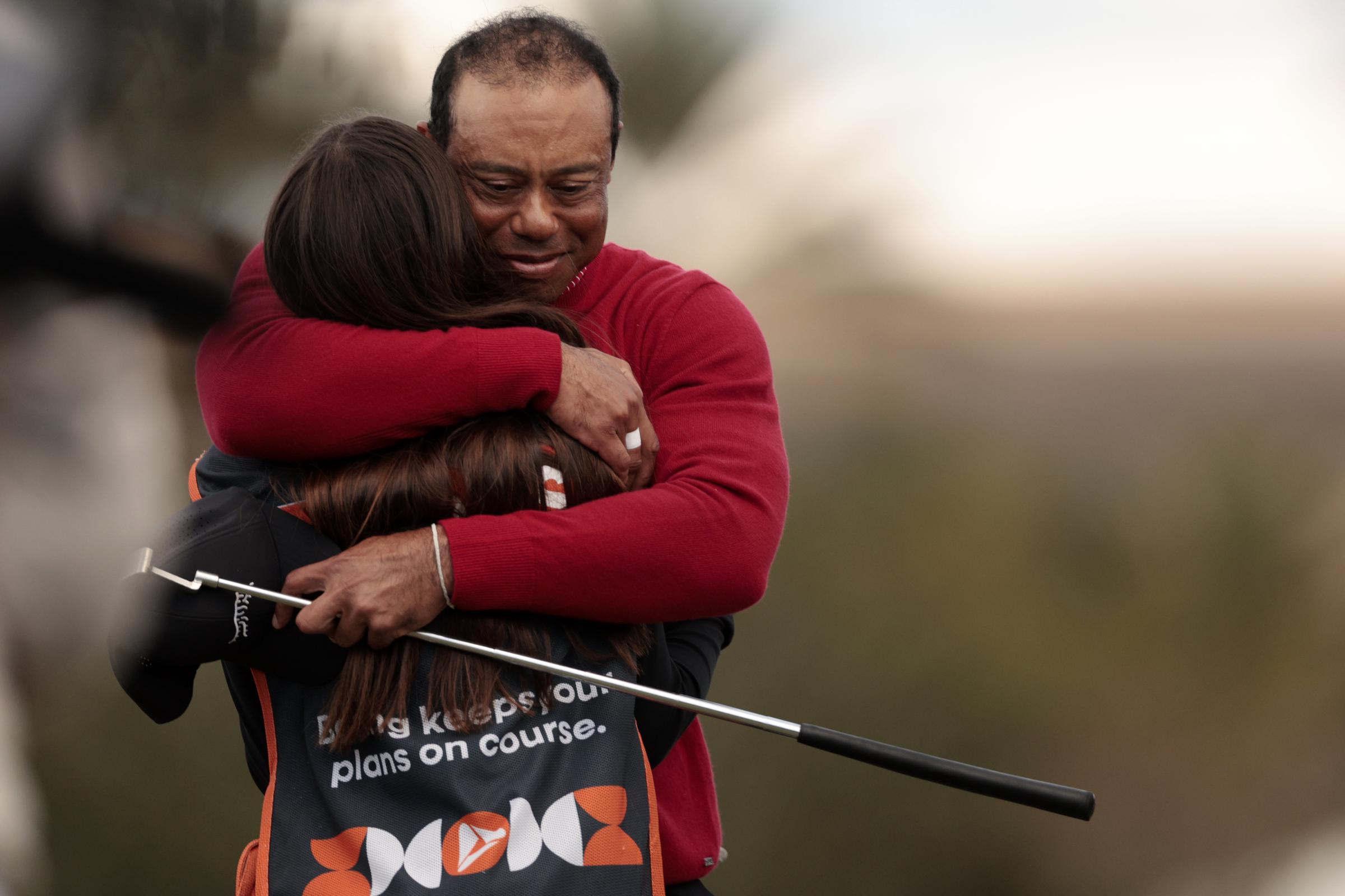 Tiger Woods hugs Sam Woods after their round on the 18th green during a sudden-death playoff during the second round of the PNC Championship at Ritz-Carlton Golf Club on December 22, 2024, in Orlando, Florida | Source: Getty Images