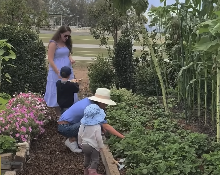 Meghan Markle and an unidentified woman gardening with the kids | Source: YouTube/LMT