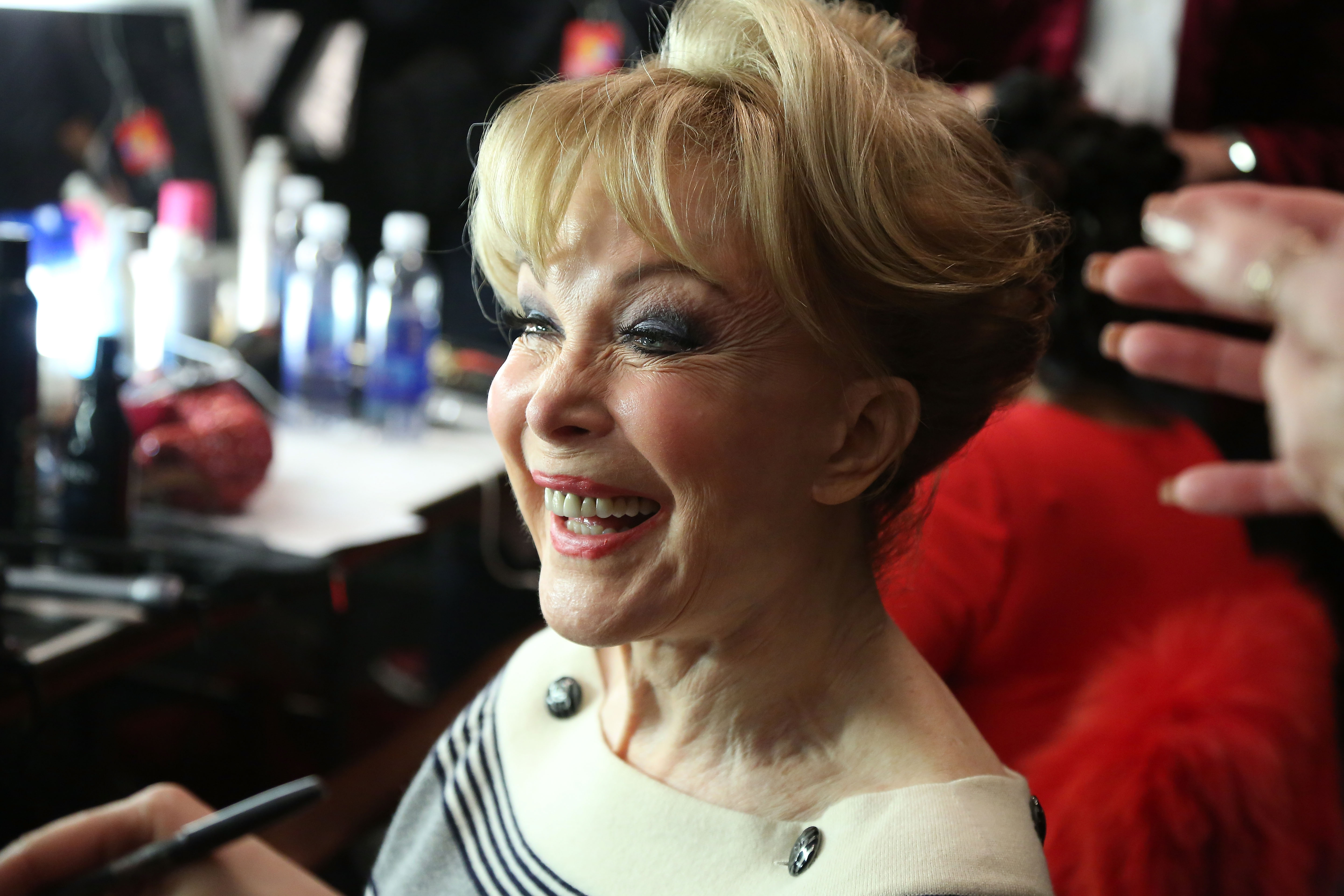 Barbara Eden smiles while getting ready backstage in 2015. Candid moments like this gave fans another close look at her face, leading many to compare recent photos with images from earlier decades. | Source: Getty Images
