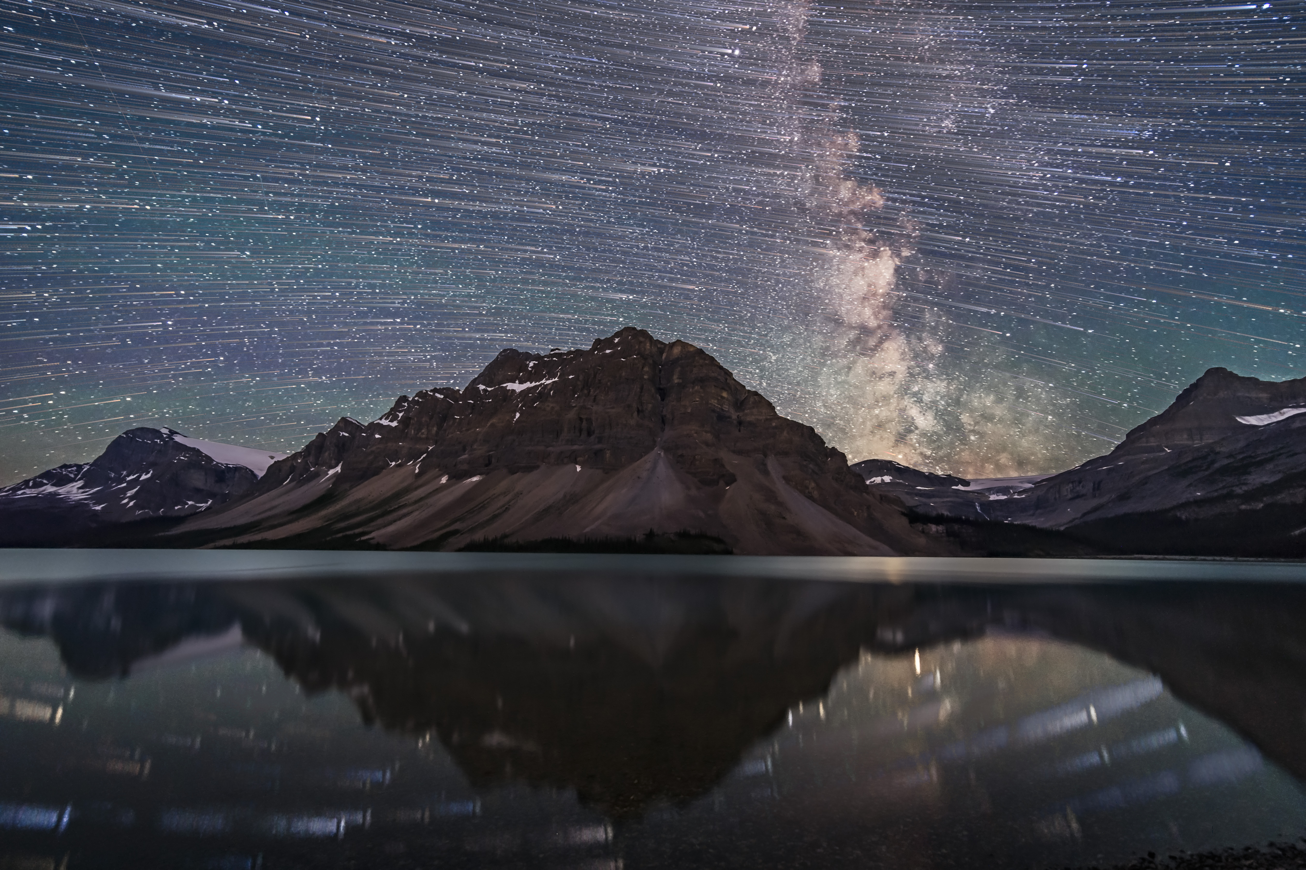 A blend of images to show the stars of the southern sky moving from east to west left to right over the Rocky Mountains at Bow Lake in Banff, Alberta. | Source: Getty Images