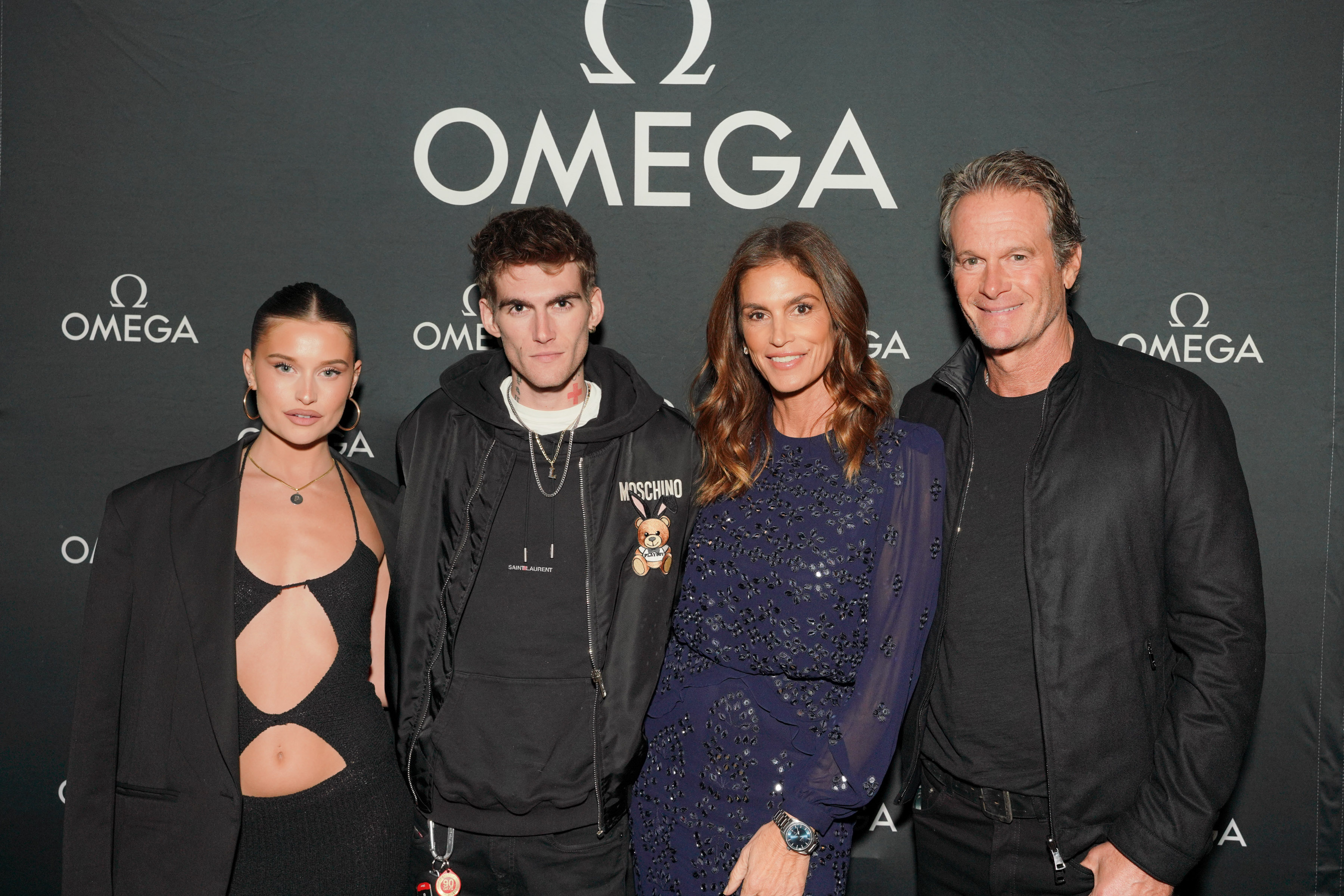 Presley Gerber and then-girlfriend Lexi Wood posed alongside Cindy Crawford and Rande Gerber at Nobu Malibu on November 3, 2022, in Malibu, California, celebrating the Haute Living and OMEGA event honoring Crawford. The group showed off a chic, moody color palette, with Presley bringing a relaxed streetwear edge in a black hooded sweatshirt and a Moschino jacket layered over layered chain necklaces. | Source: Getty Images