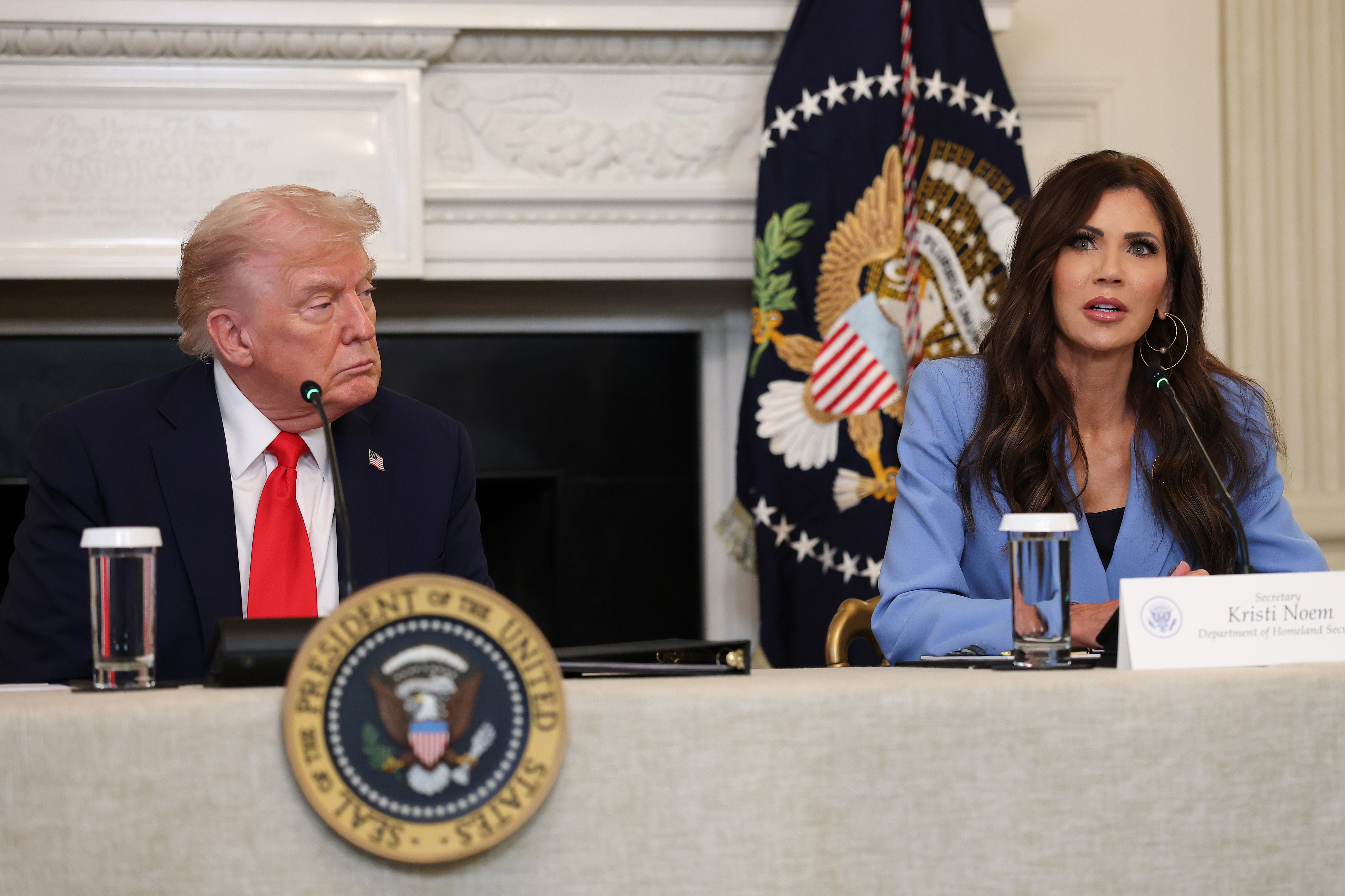 Donald Trump and Kristi Noem during a roundtable discussion in the State Dining Room of the White House in Washington, D.C., on October 8, 2025. | Source: Getty Images
