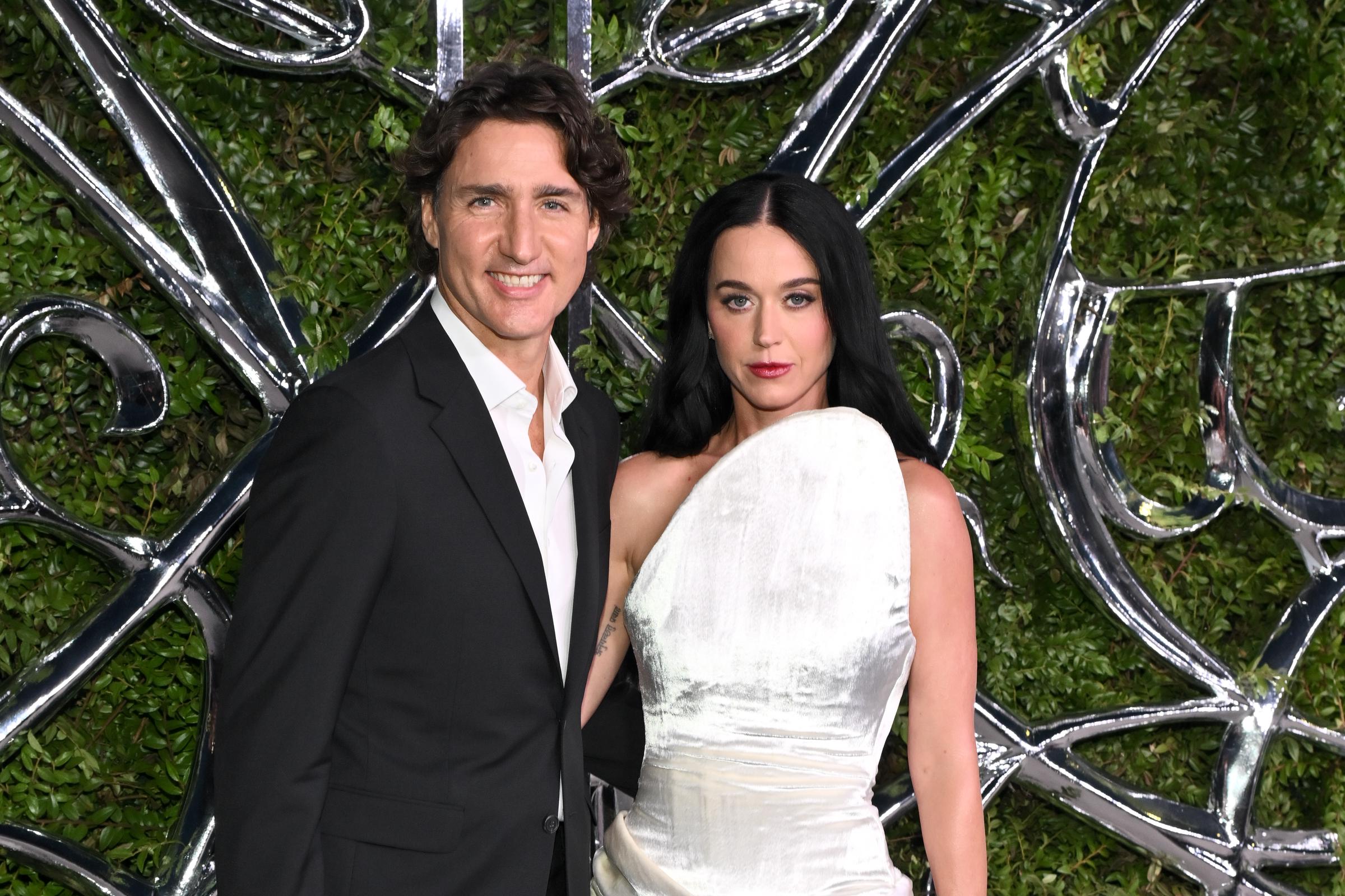 Katy Perry and Justin Trudeau initially posed side by side, with Perry's sculptural white one-shoulder gown contrasting with Trudeau's black suit. The photograph offered a more formal look at the pair before later frames captured closer interactions. | Source: Getty Images