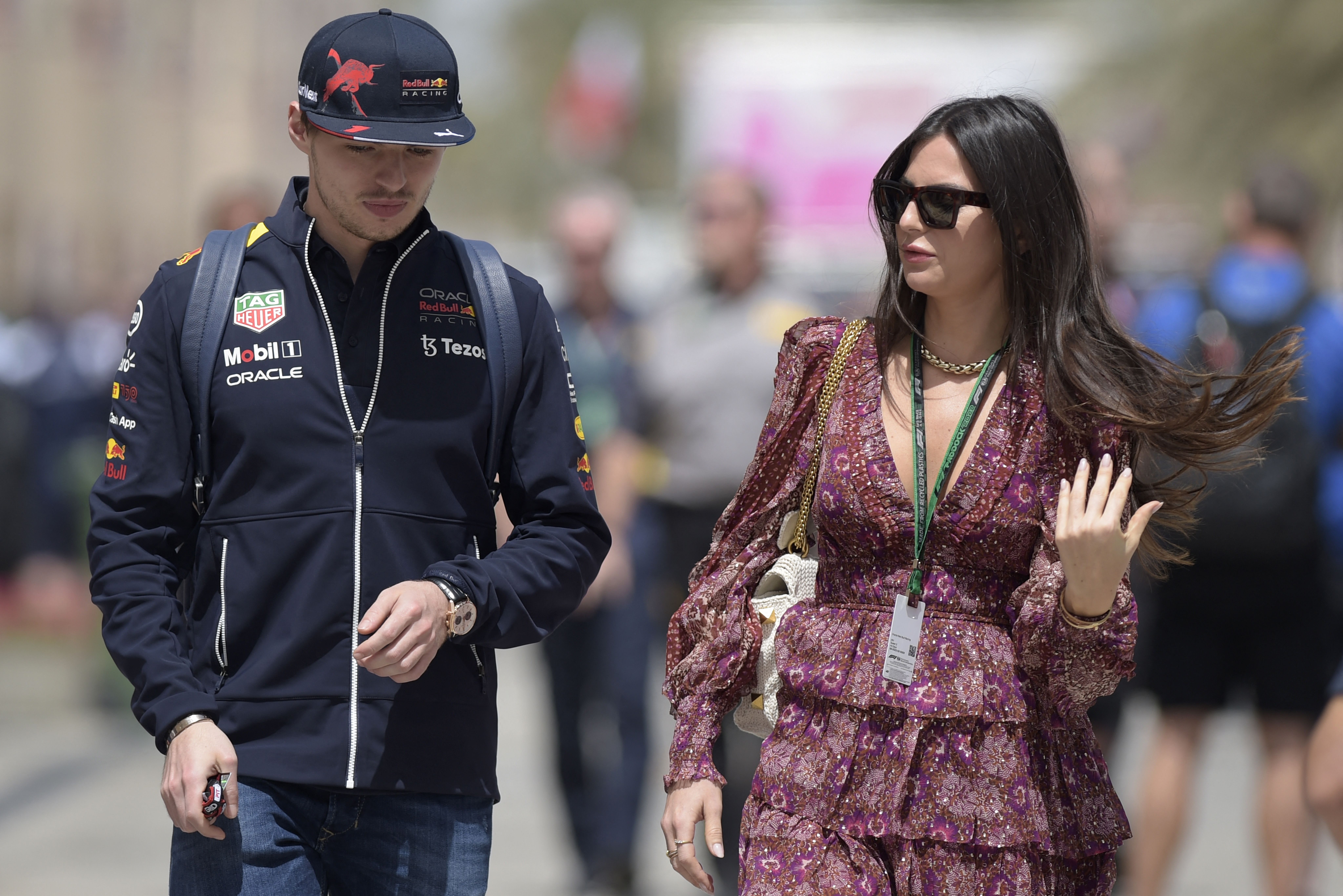 Max Verstappen arrives with Kelly Piquet ahead of the third practice session ahead of the Bahrain Formula One Grand Prix at the Bahrain International Circuit in Sakhir on March 19, 2022, capturing a moment of relaxed focus before the intense track action.