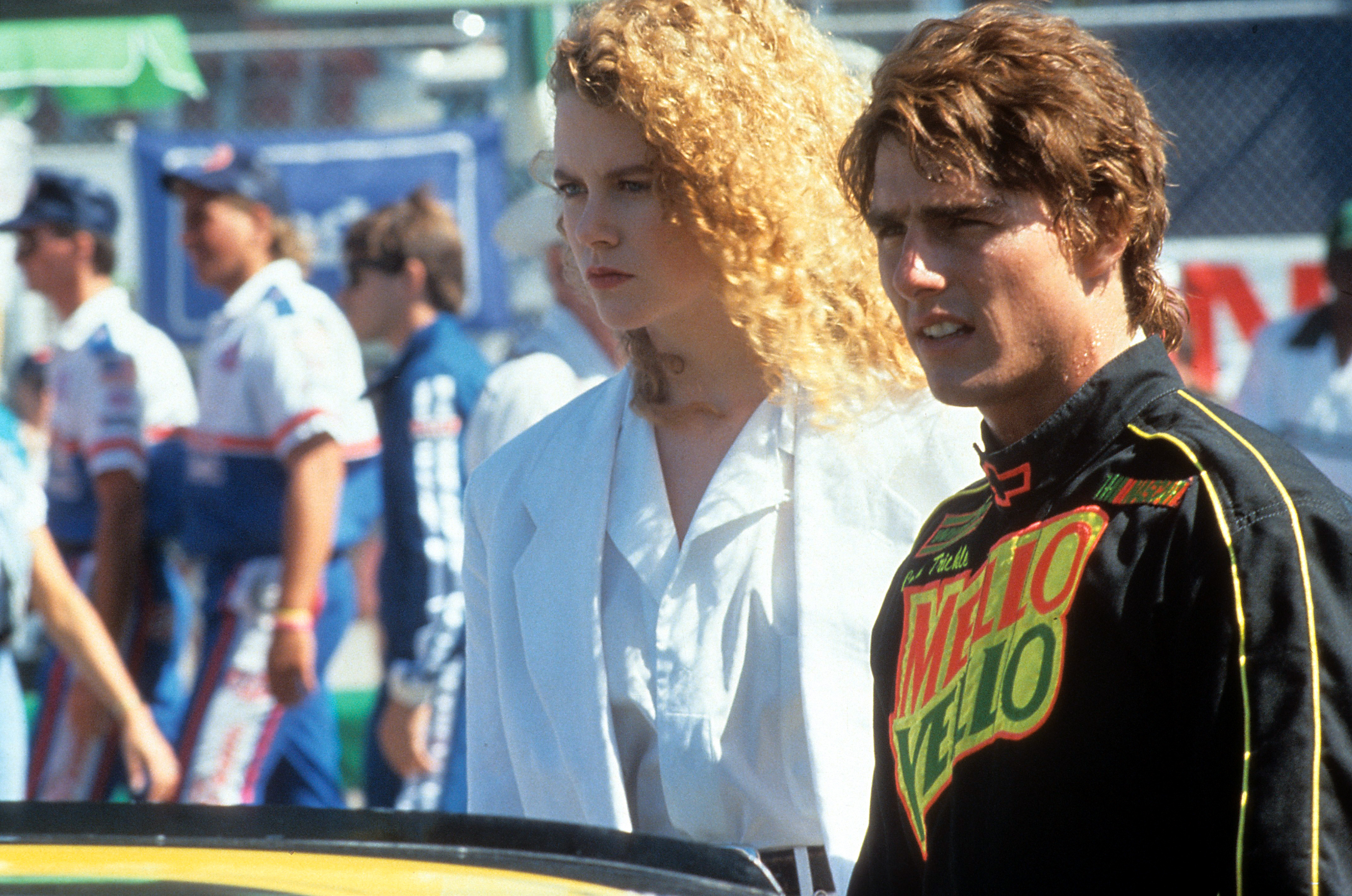 Nicole Kidman and Tom Cruise appear together at the racetrack in a scene from "Days of Thunder." Kidman plays Dr. Claire Lewicki, while Cruise appears in Cole Trickle's racing suit beside her. | Source: Getty Images
