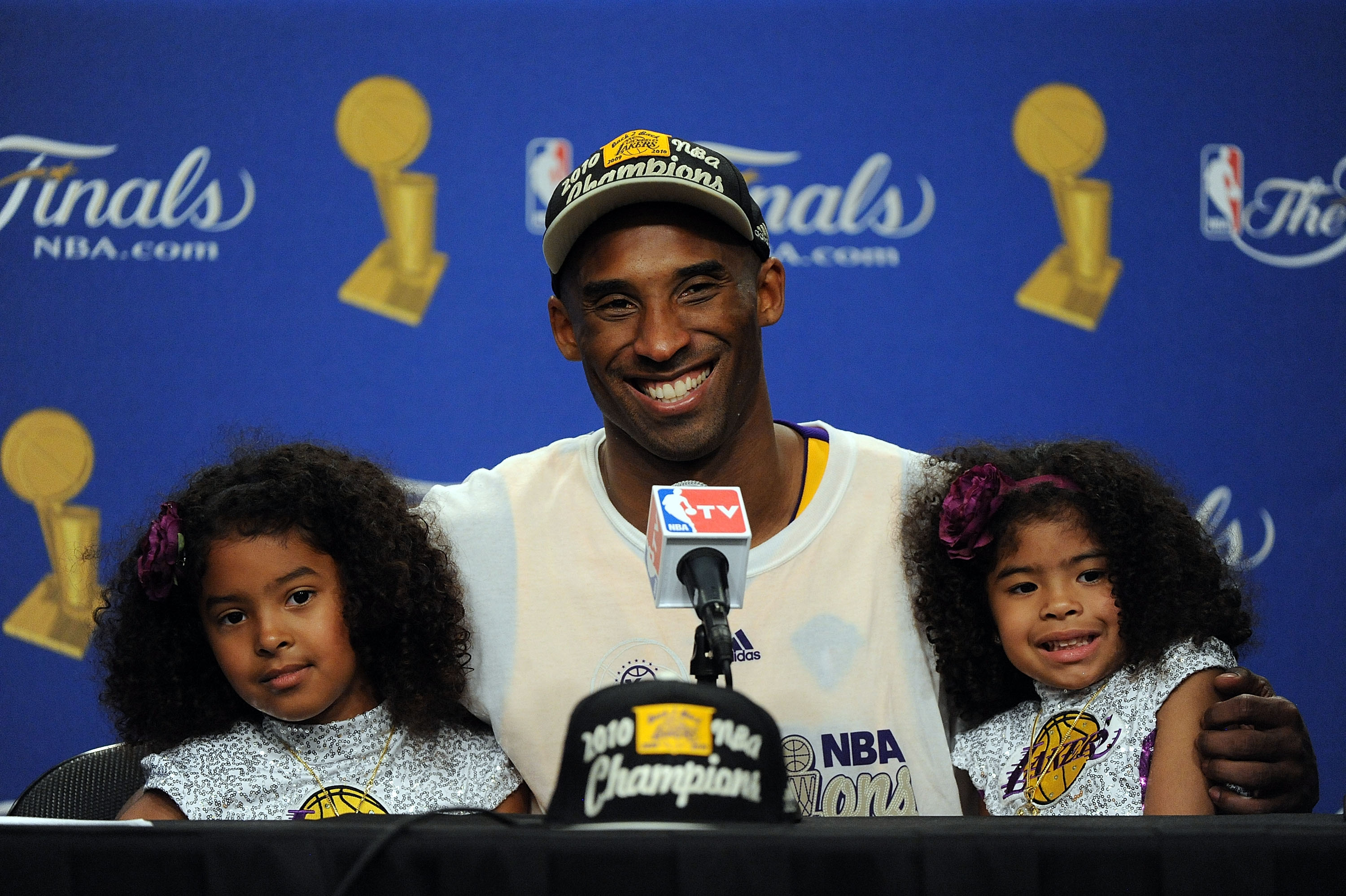 Kobe Bryant shares a joyful moment with daughters Natalia Diamante Bryant and Gianna Maria-Onore Bryant during the postgame news conference after the Los Angeles Lakers defeated the Boston Celtics in Game Seven of the NBA Finals.