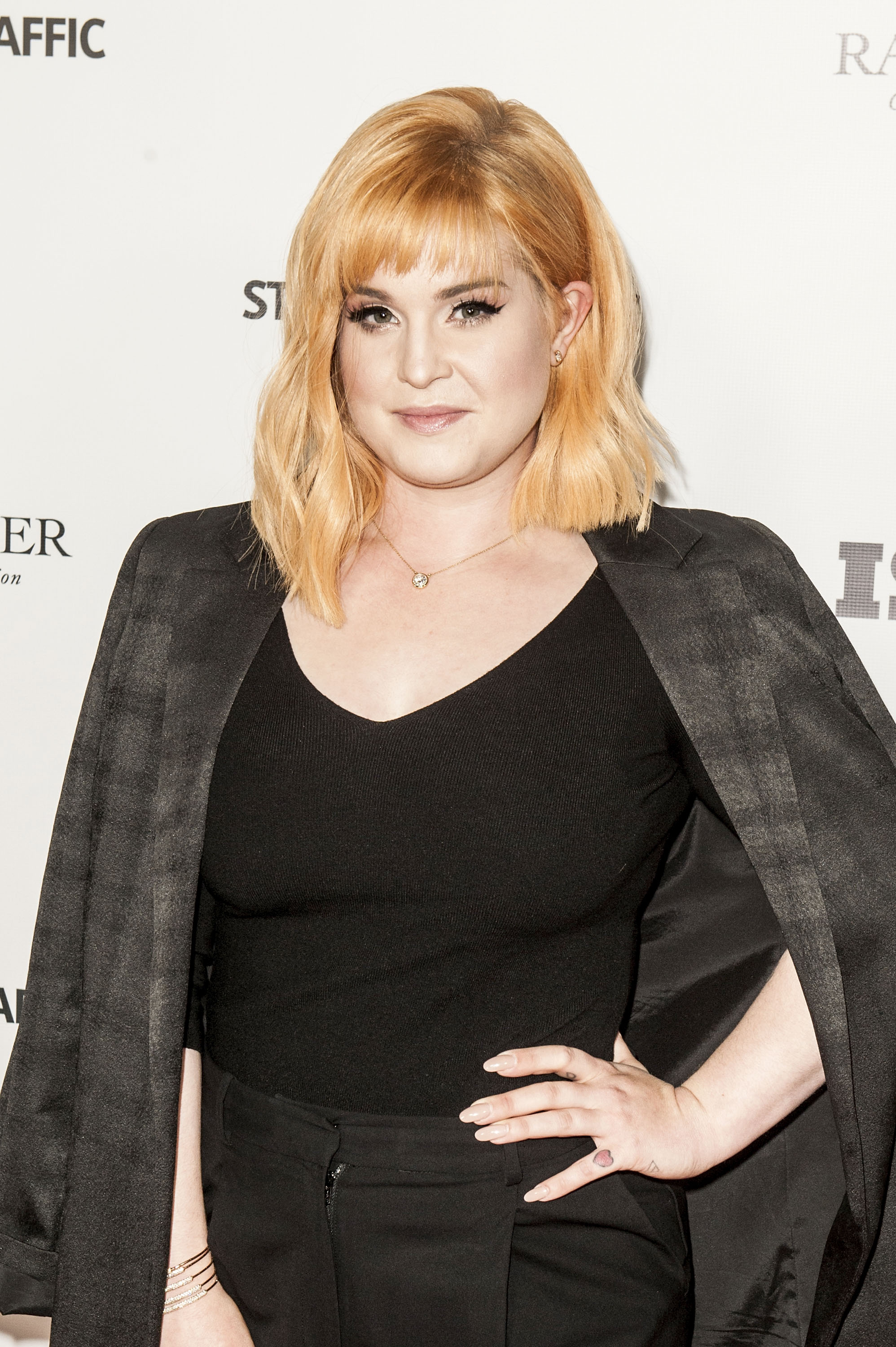 Kelly Osbourne arrives at the premiere of "Stopping Traffic: The Movement to End Sex Trafficking" in Hollywood on September 26, 2017, showcasing a chic copper-blonde hairstyle and an elegant all-black look. | Source: Getty Images