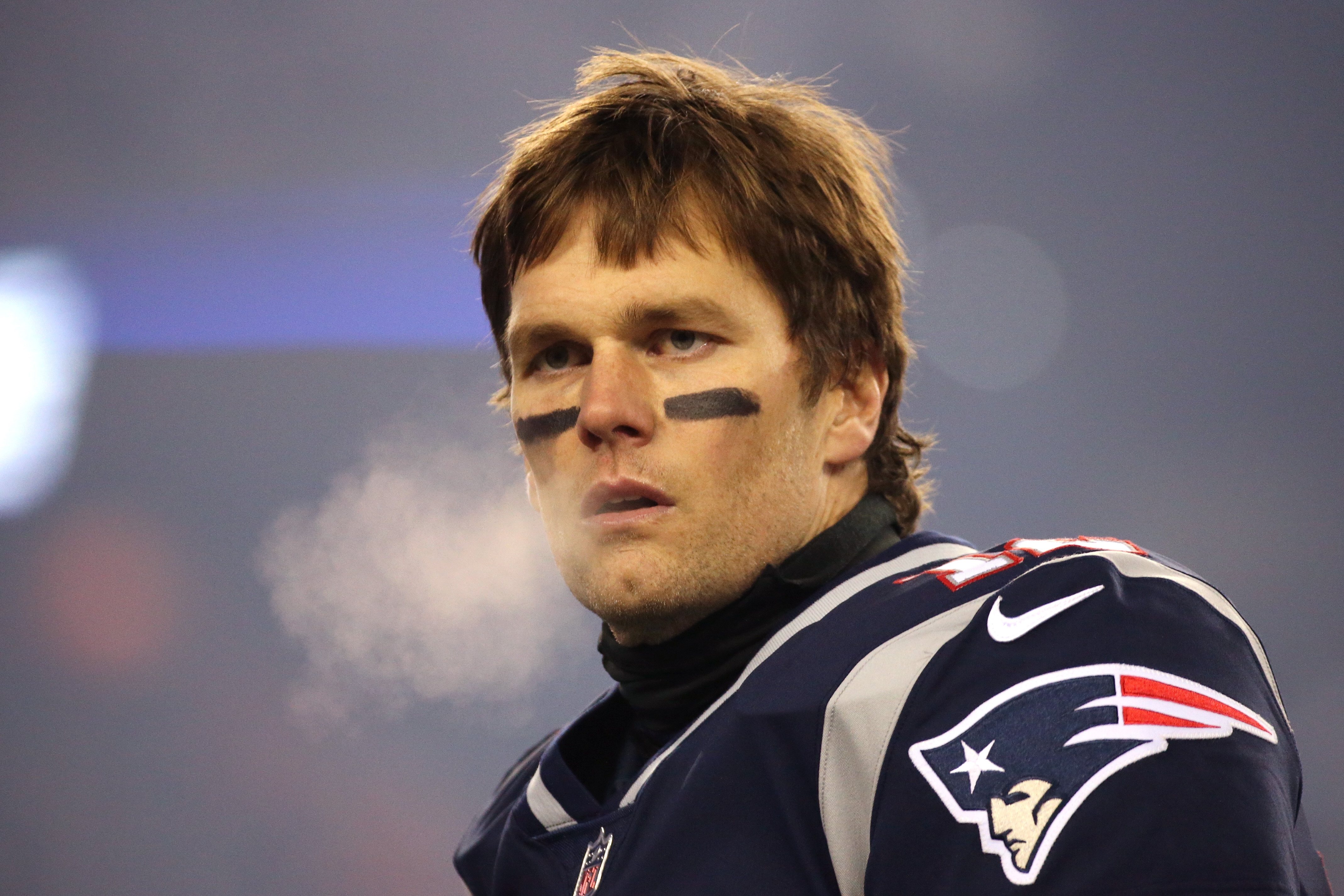 With a trademark look of calm intensity, Tom Brady surveys the field before the AFC Divisional Playoff game against the Tennessee Titans at Gillette Stadium.