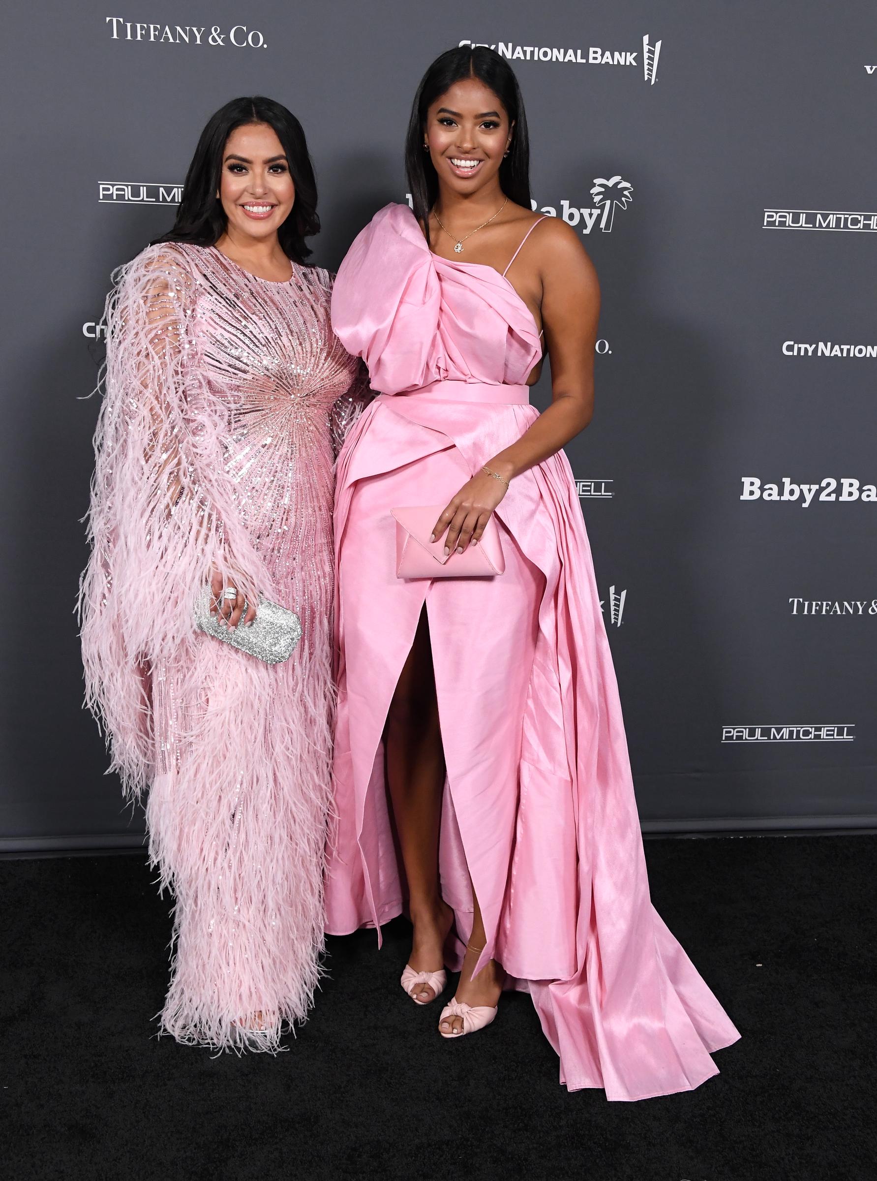 Vanessa Bryant and Natalia Diamante Bryant pose together at the Baby2Baby 10-Year Gala, with Natalia standing tall beside her mother in a striking pink gown with an oversized sculptural detail.