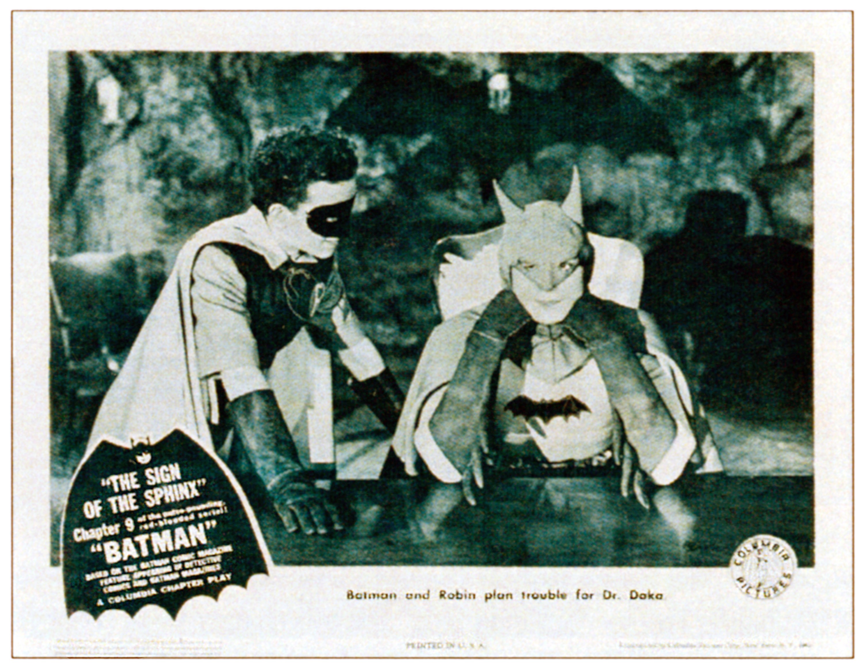 Douglas Croft as Robin stands beside the first live-action Batman in a lobby card from Chapter 9, "The Sign of the Sphinx," in the 1943 "Batman" serial. | Source: Getty Images