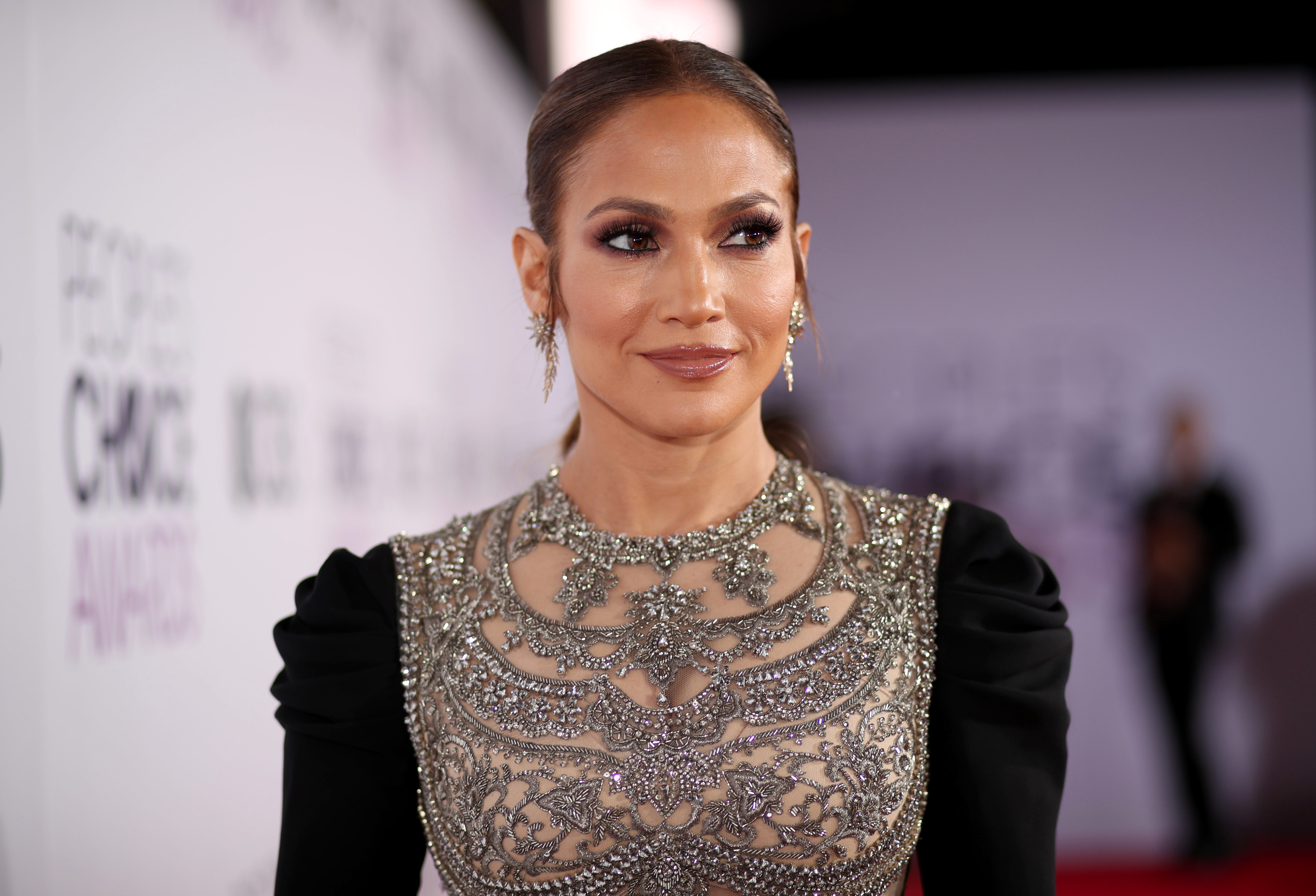 Jennifer Lopez commanded attention in a dramatic black gown with long black sleeves that featured a richly embellished bodice. The entire outfit gave her her usual opulent, high-fashion look that merged regal detailing with sleek sophistication.