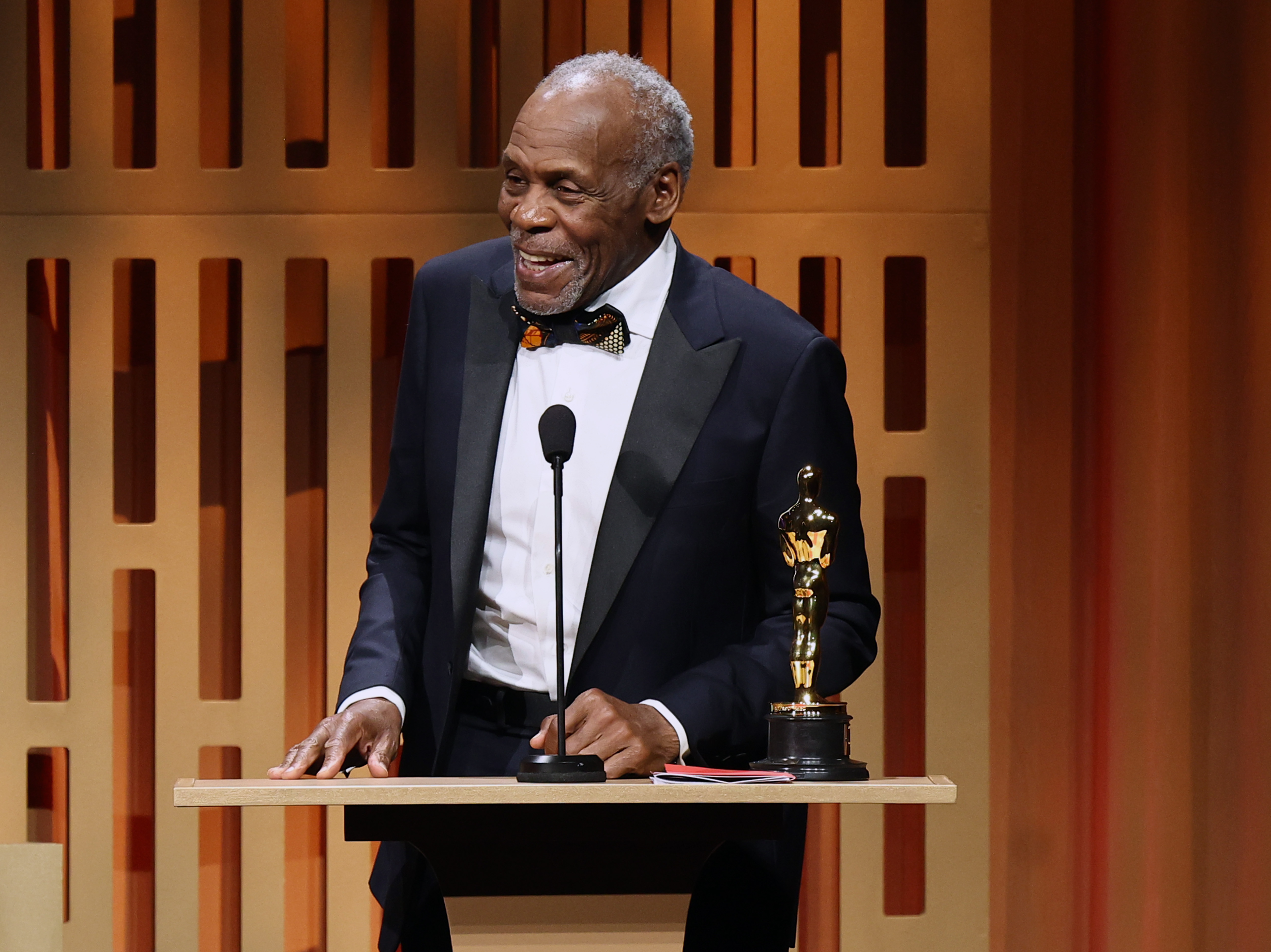 Danny Glover accepts the Jean Hersholt Humanitarian Award at the Governors Awards, an honor he later revealed came shortly after he was diagnosed with Alzheimer's disease—a milestone that took on new meaning as he privately began navigating life with the condition. | Source: Getty Images