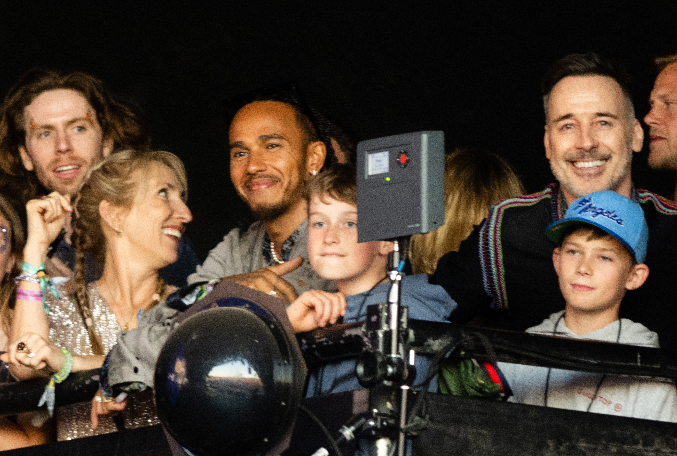 Zachary and Elijah Furnish-John with Lewis Hamilton, Sam Taylor-Johnson, and David Furnish on Day 5 of Glastonbury Festival 2023 on June 25. | Source: Getty Images