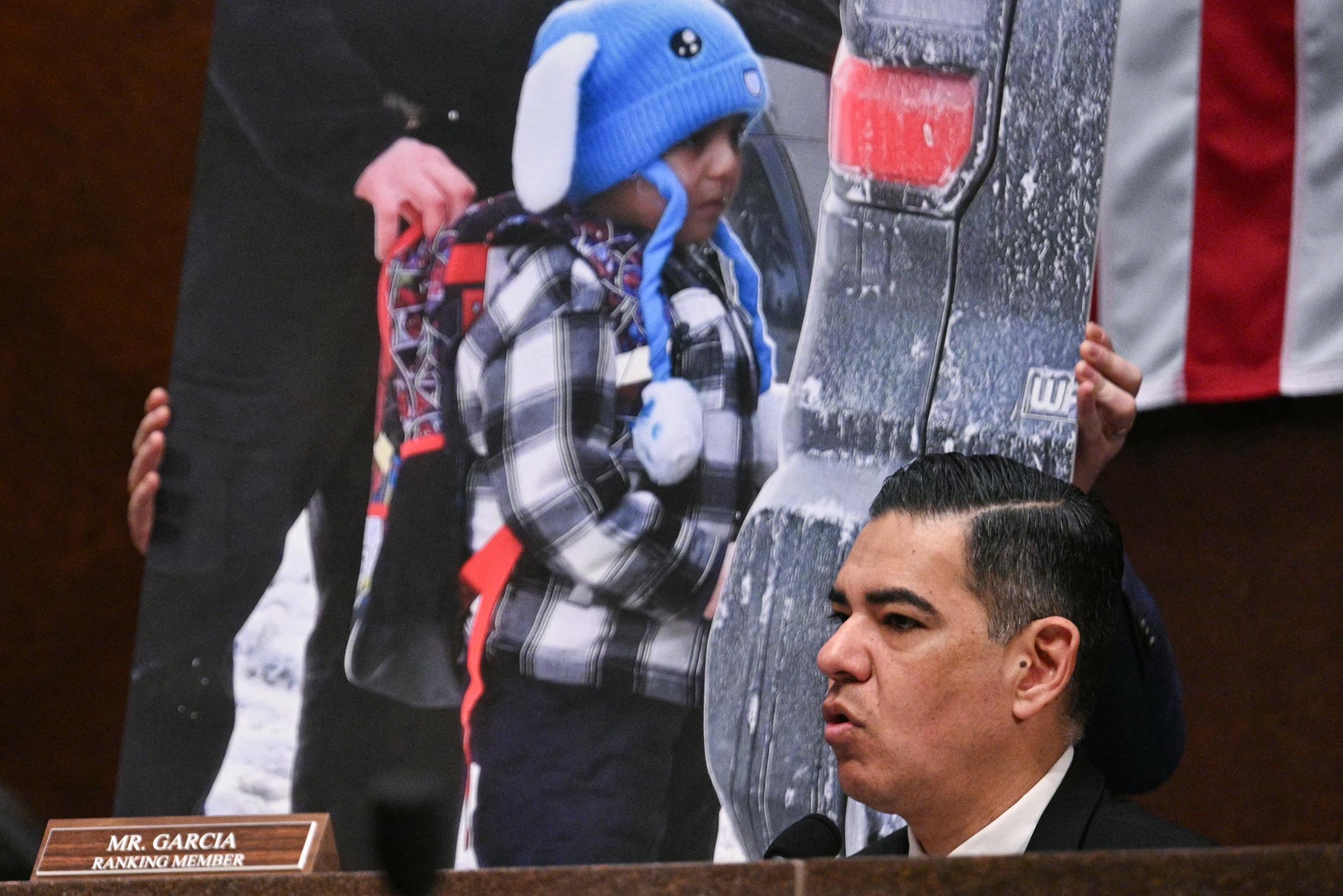 U.S. Representative Robert Garcia speaks during a March 4, 2026 hearing, with an image of Liam Conejo Ramos following his January 2026 detention | Source: Getty Images