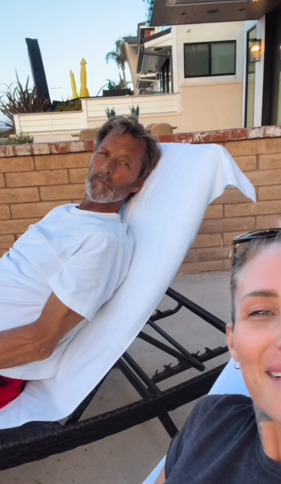 Duguay reclines outdoors on a lounge chair, with Thomas partly visible beside him. The peaceful setting offers a contrast to the hospital scenes included in her account of his treatment. | Source: Instagram/mrs__shay