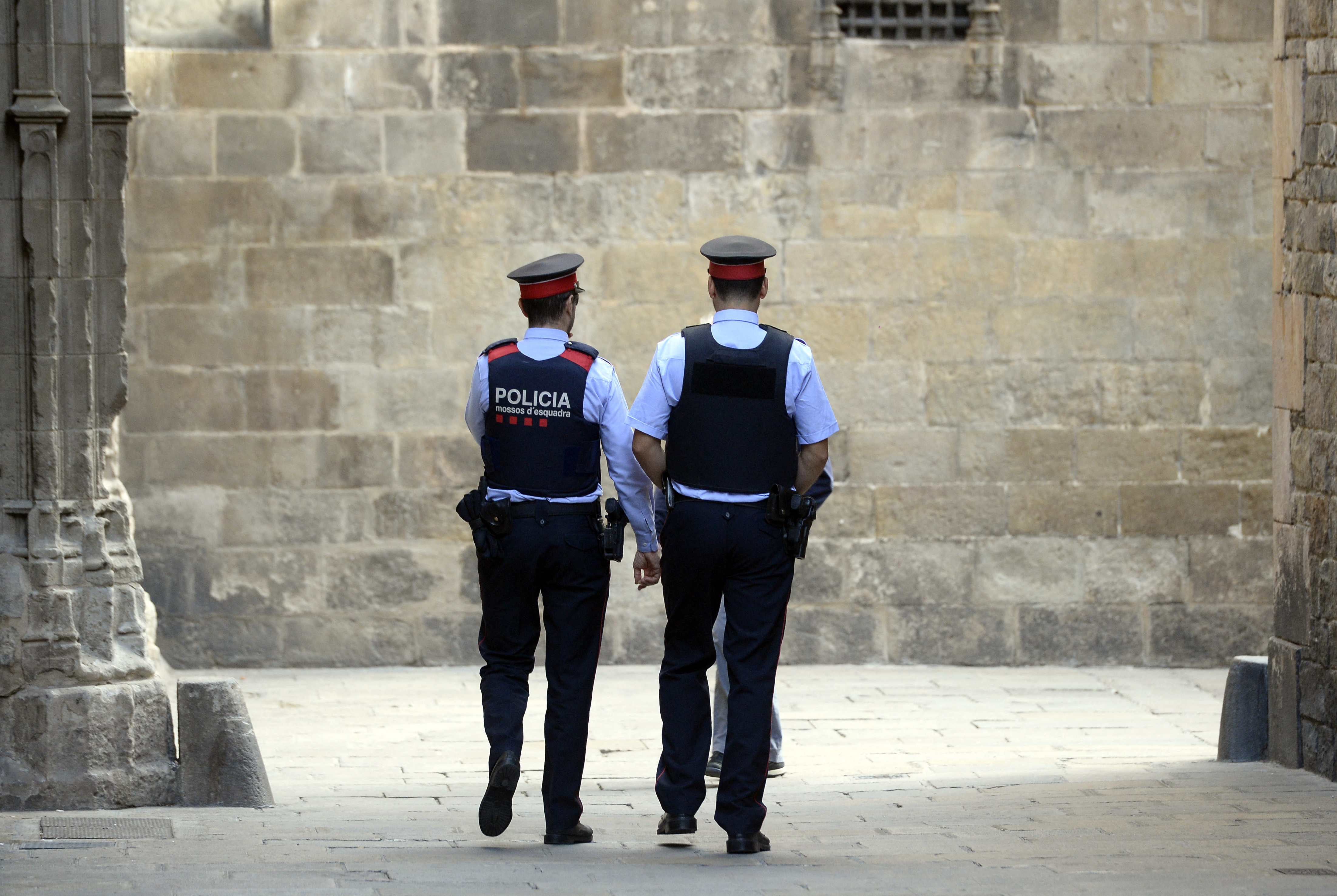 Two 'Mossos D'Esquadra' (Catalan police officers) seen walking in Barcelona | Source: Getty Images