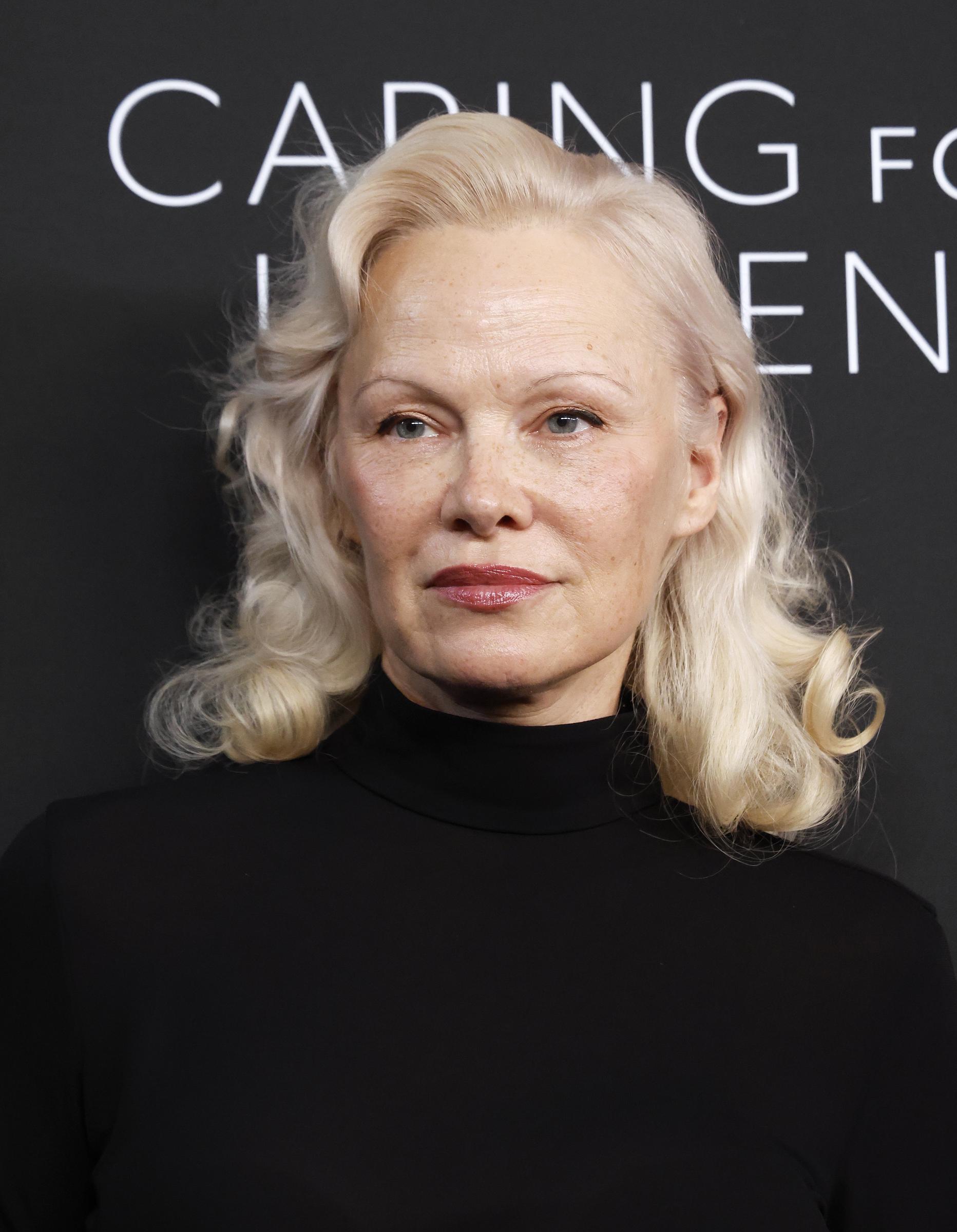 Pamela Anderson has embraced a more natural, makeup-free look in recent years, but her platinum blonde hair remains a signature feature — one she continues to maintain herself at home. | Source: Getty Images