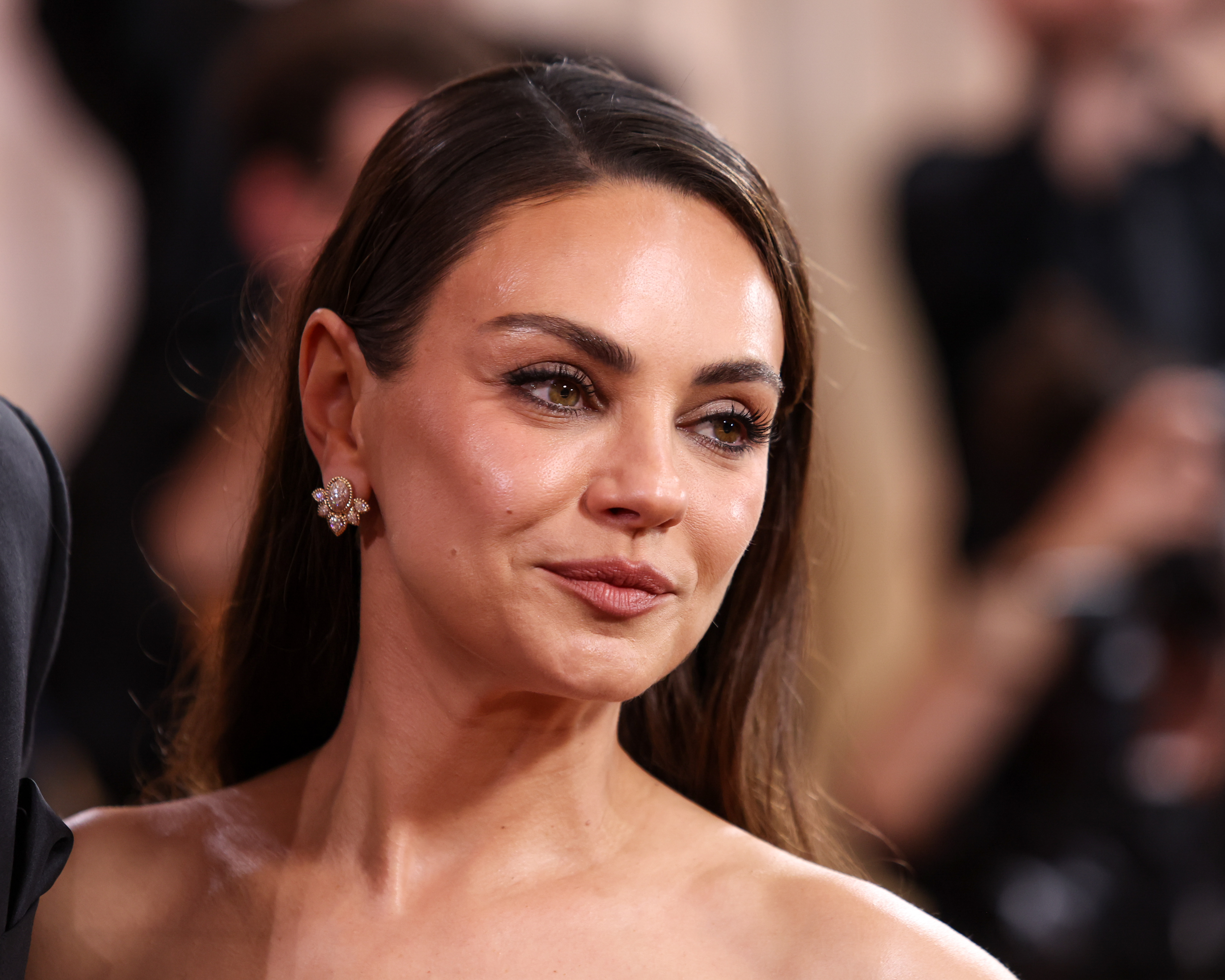 Mila Kunis attends a red carpet event. Before the 2011 Golden Globes, Scott Vincent Borba gave the actress his widely publicized $7,000 Diamond and Ruby Facial, one of his most famous celebrity skincare treatments. | Source: Getty Images
