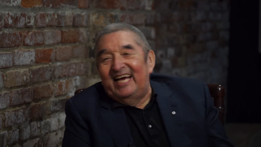 Graham Greene shares a laugh with R.H. Thompson as he recounts a story about his wife, Hilary Greene, and actor James Garner, from an interview posted on March 11, 2024 | Source: Youtube/Canada's Theatre Museum