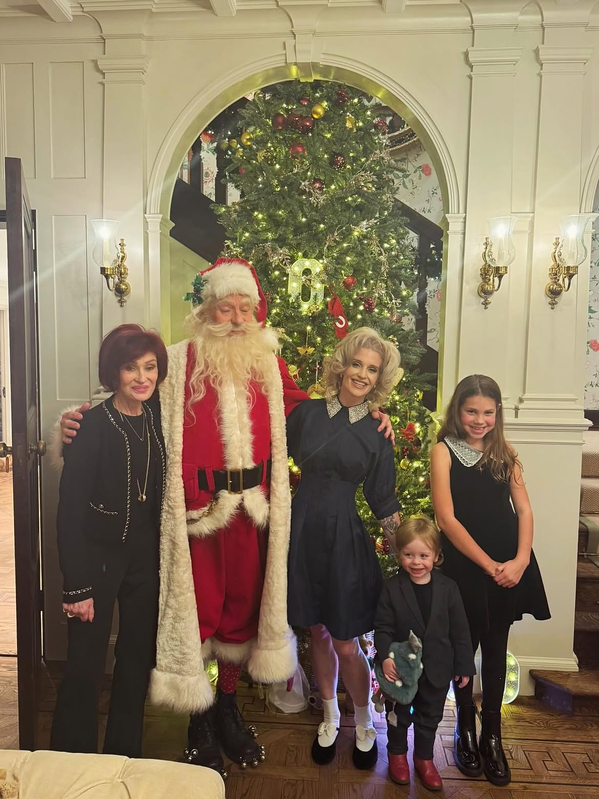 The Osbournes planned a traditional English Christmas in December 2025, with 14 relatives expected at Sharon's Buckinghamshire home. The photographs show a towering decorated tree, Santa Claus, and several generations of the family celebrating together. | Source: Instagram/@kellyosbourne
