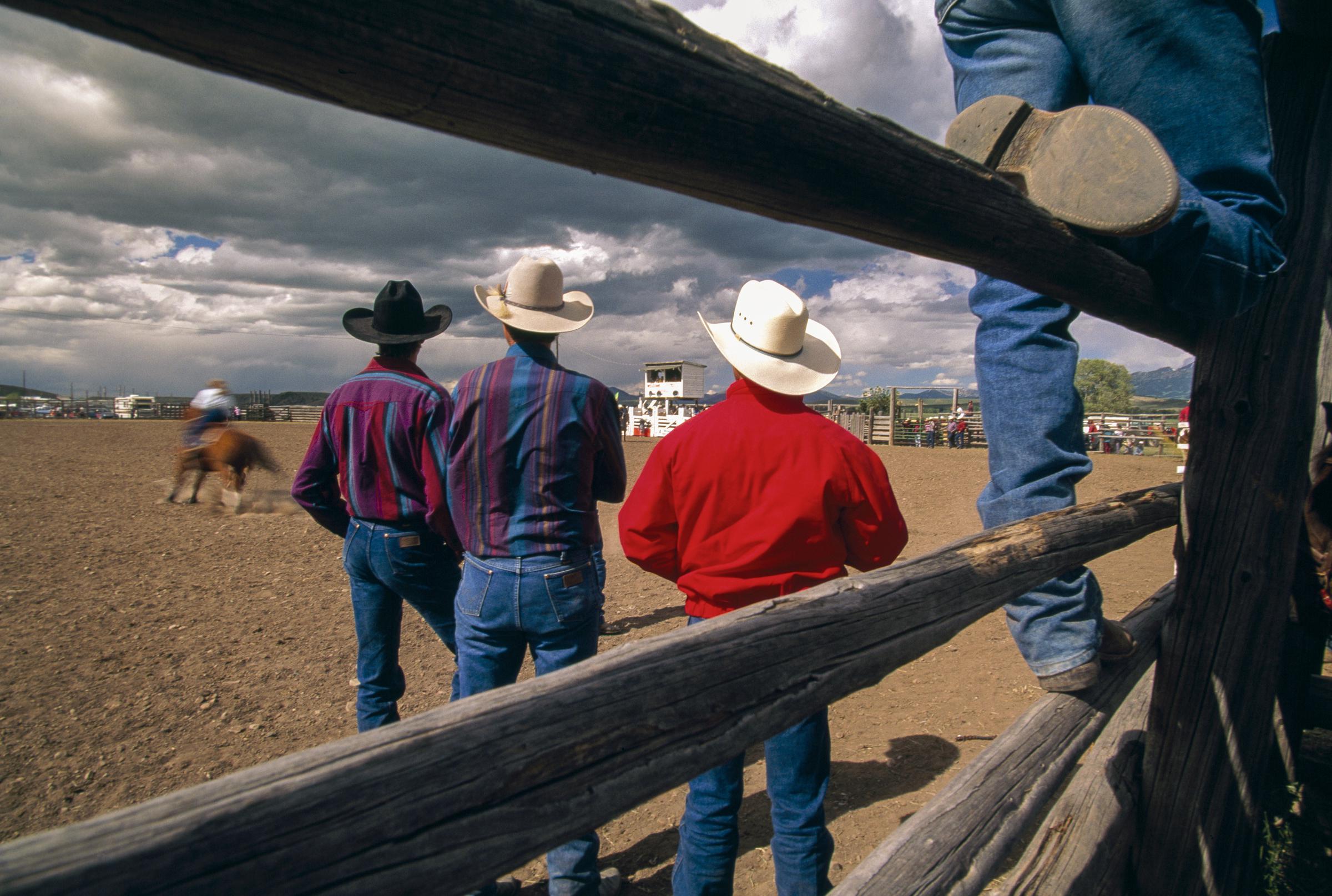Cowboys watch a rodeo under sunny skies in Mullen, Nebraska, on July 7, 2023 | Source: Getty Images