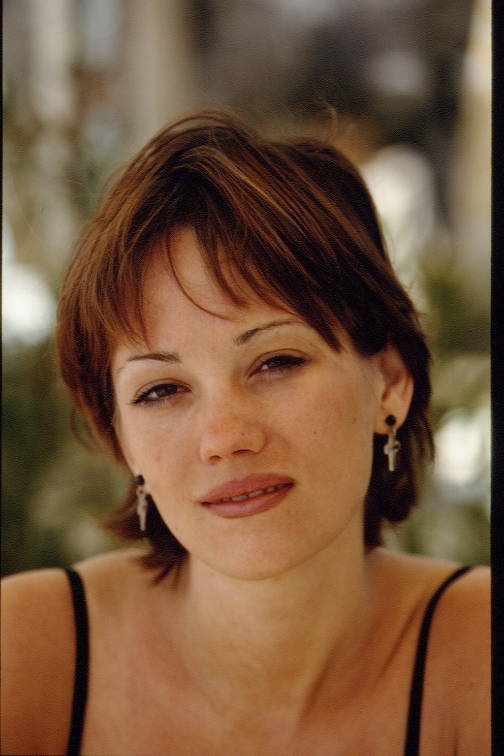 Natasha Gregson Wagner is pictured in a close-up portrait during the Cannes Film Festival in May 1994. She wears a black spaghetti strap top and cross earrings, with minimal makeup and a soft expression.