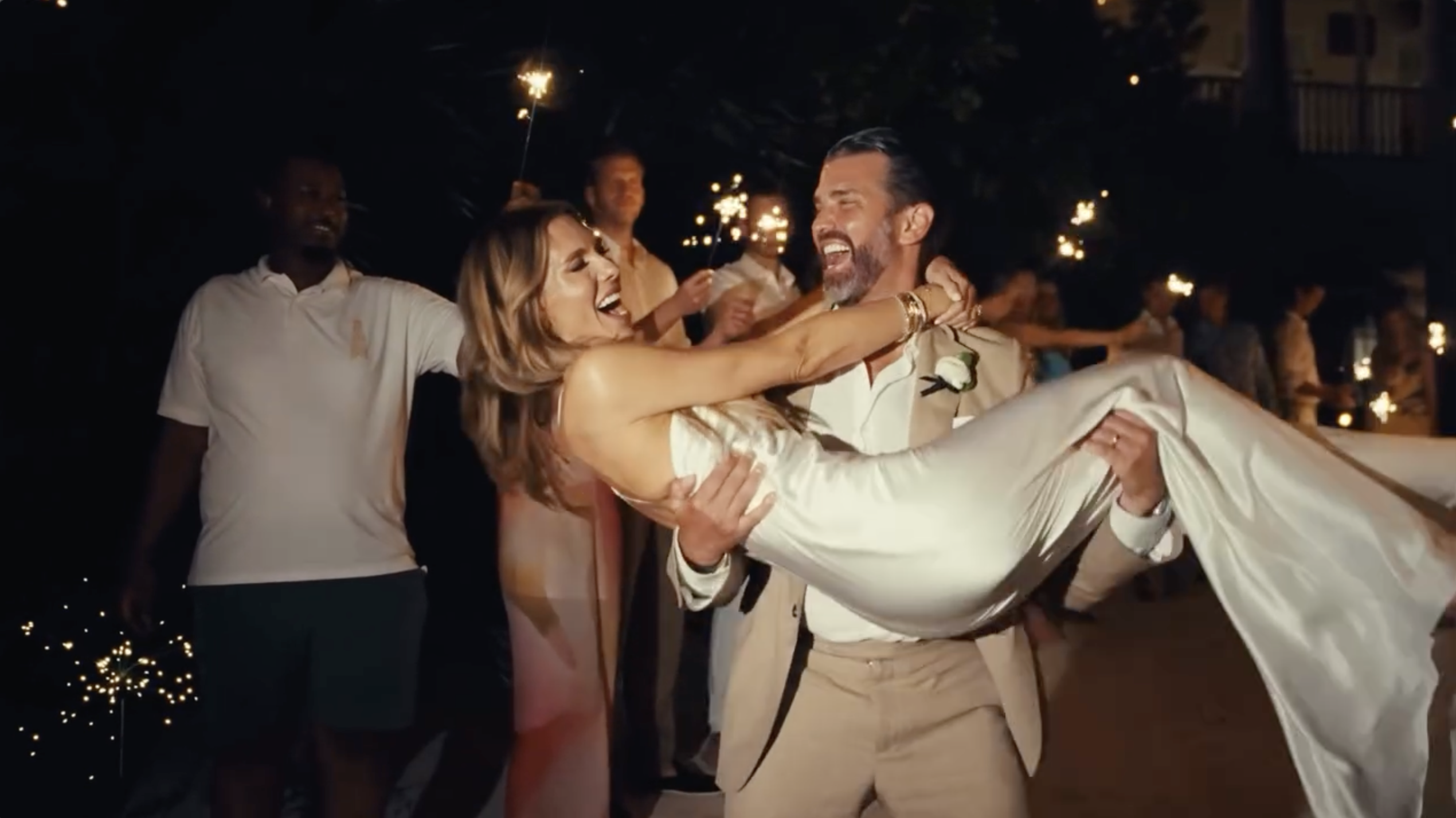 Donald Trump Jr. carries Bettina Anderson through a sparkler-lined sendoff as guests cheer during the evening celebration. | Source: Instagram/donaldjtrumpjr